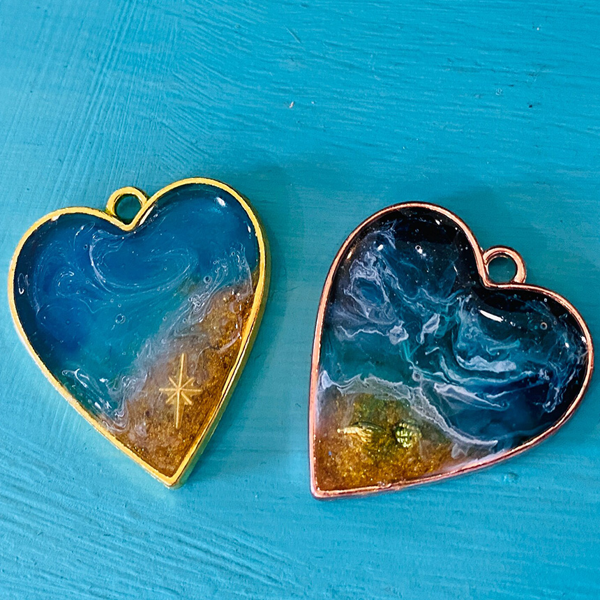 Heart shaped earrings with ocean themed enamel finish.