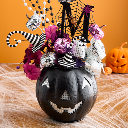 black jack-o-lantern with Halloween sprays