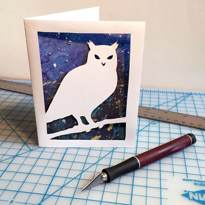 A handmade paper greeting card featuring an owl.