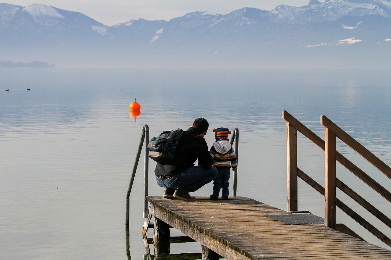 Father and son hanging out on the pier