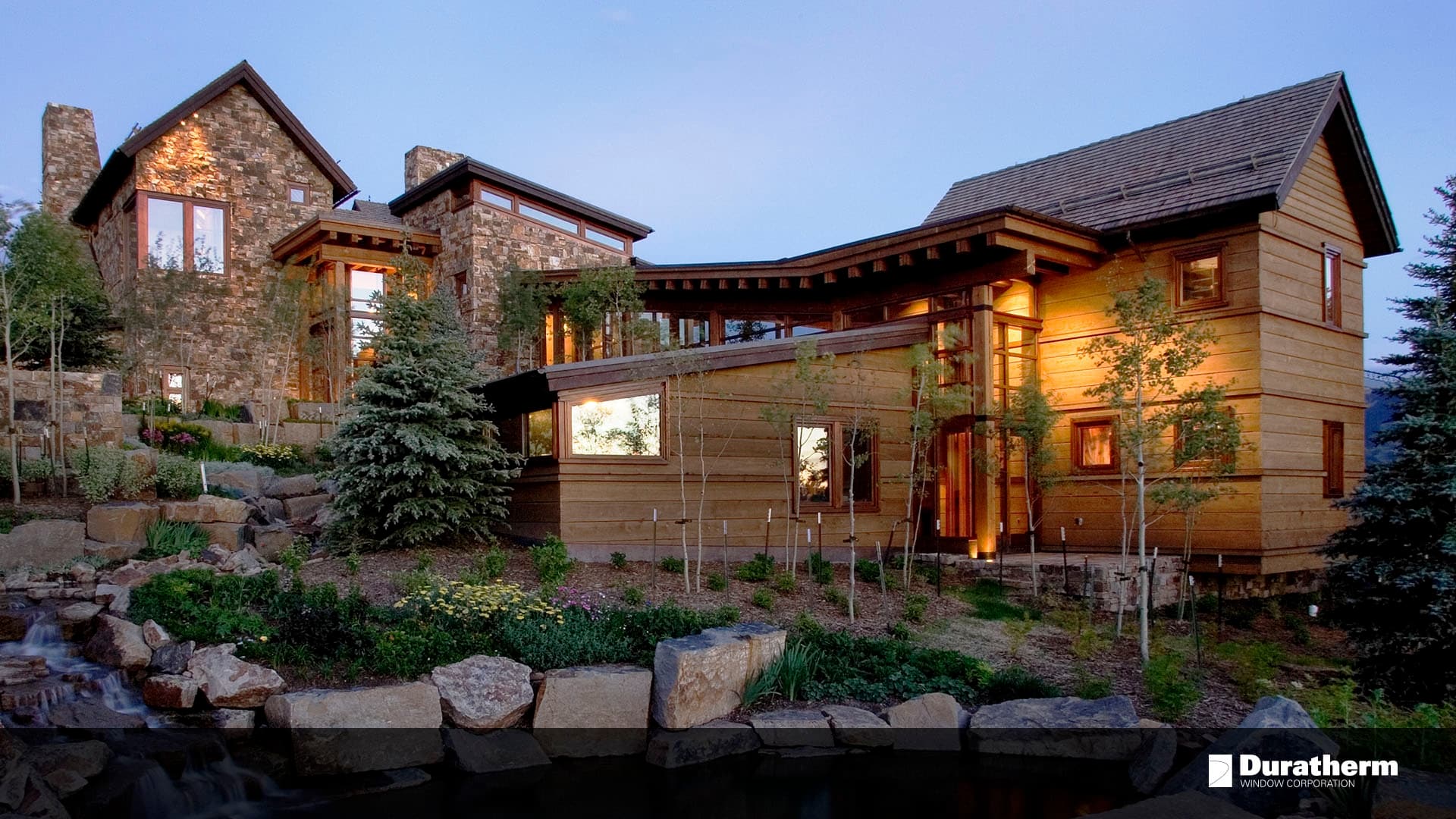mountain home with wood siding and stone