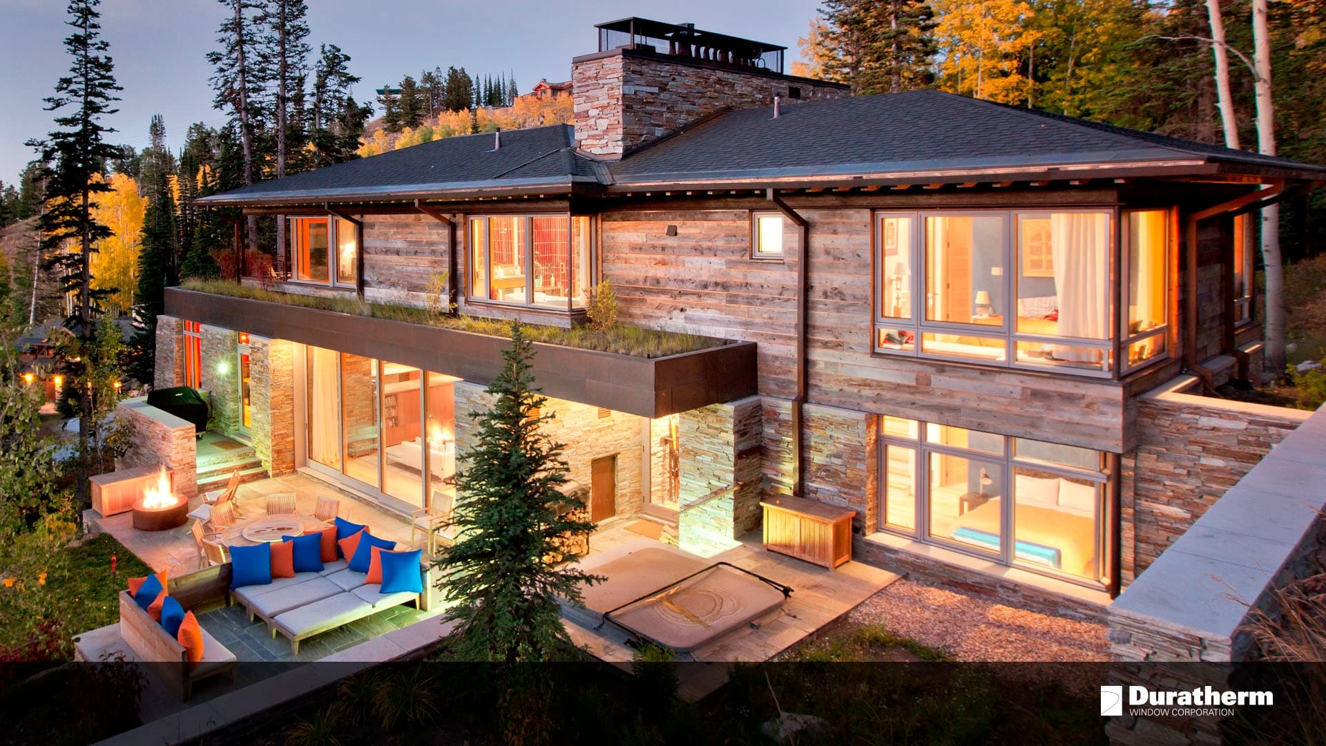 wood-sided two-story home with swinging doors and floor-to-ceiling window units