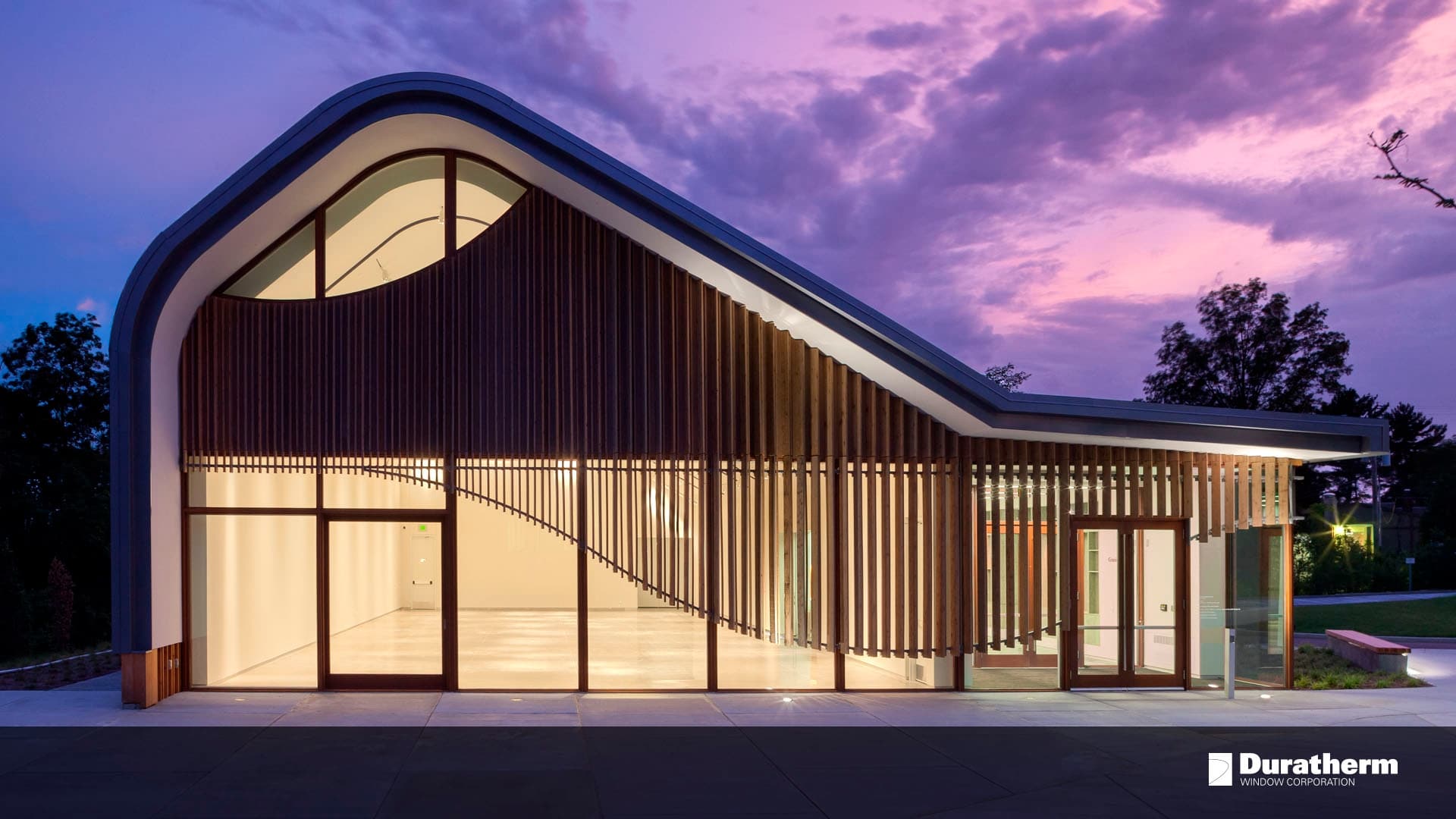 custom-designed arched building with wood accents and doors