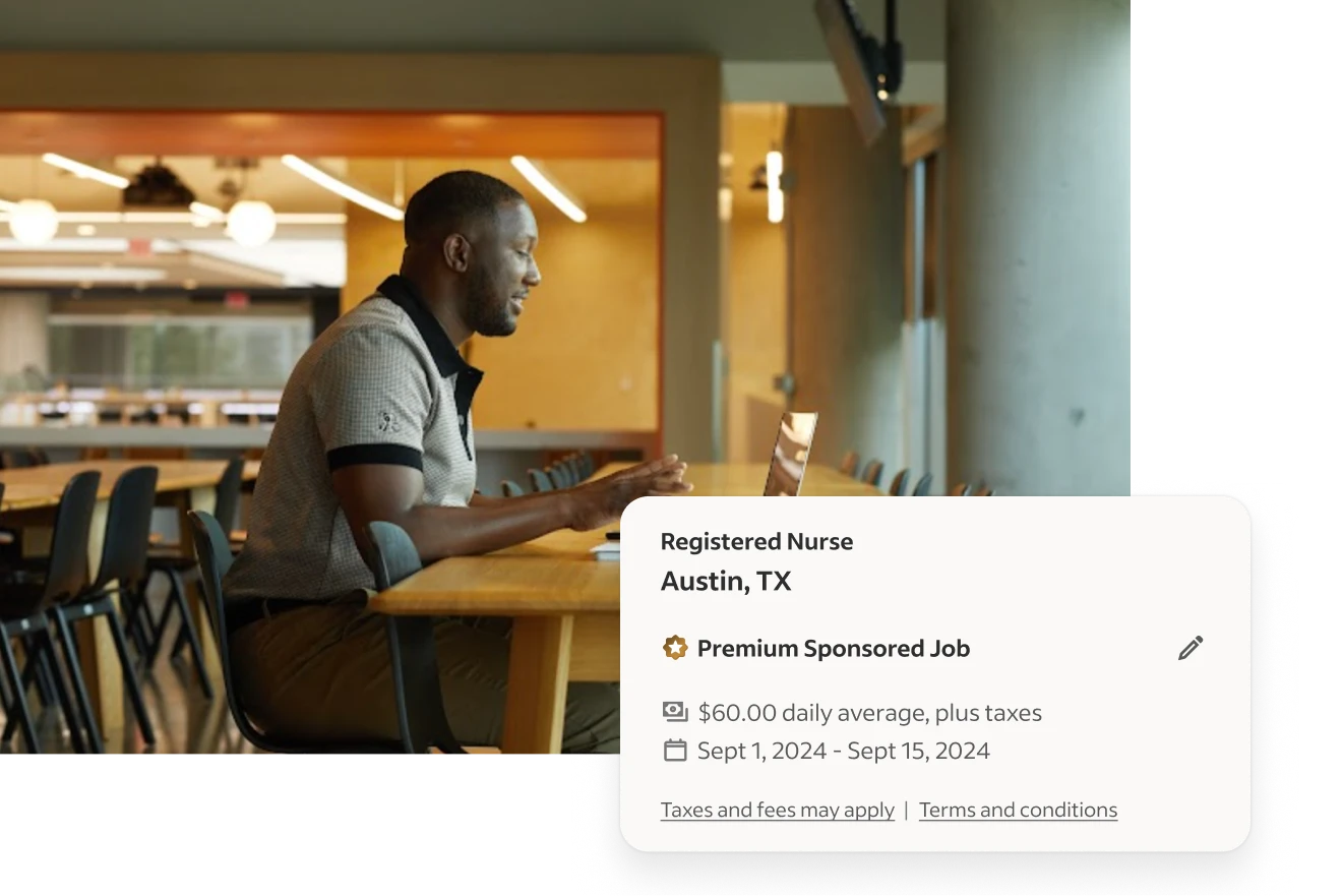 employer on laptop in office posting a premium sponsored job on Indeed