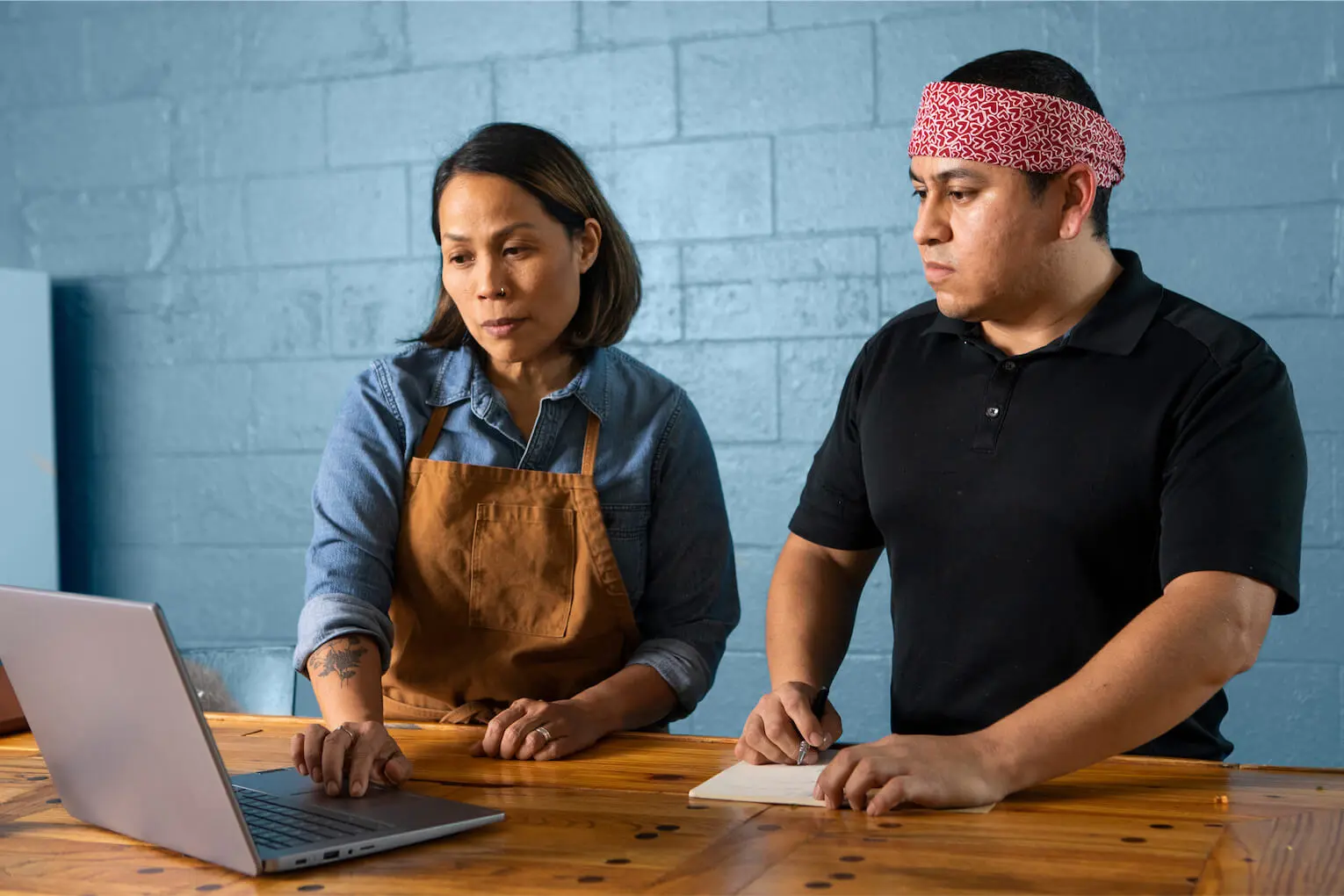 two culinary professionals exploring Indeed’s matching and hiring platform on a laptop
