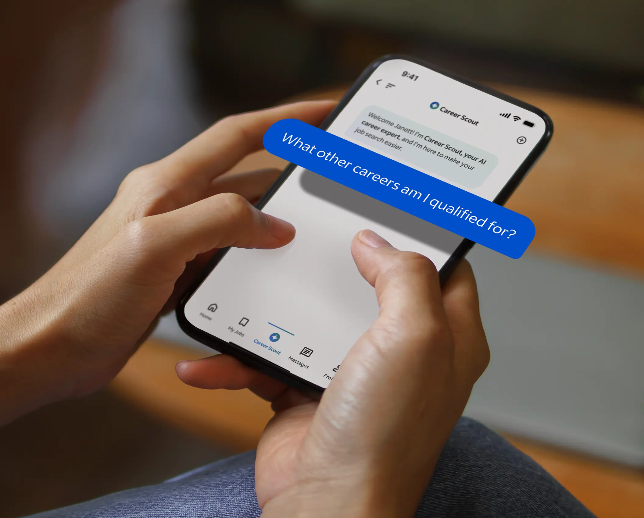 Person holding a smartphone with a chat interface. On it, a blue text bubble states, “What other careers am I qualified for?”