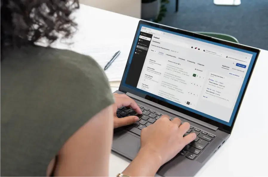 the woman’s Employer Dashboard on her laptop screen with all the tools she needs to manage hiring from start to finish