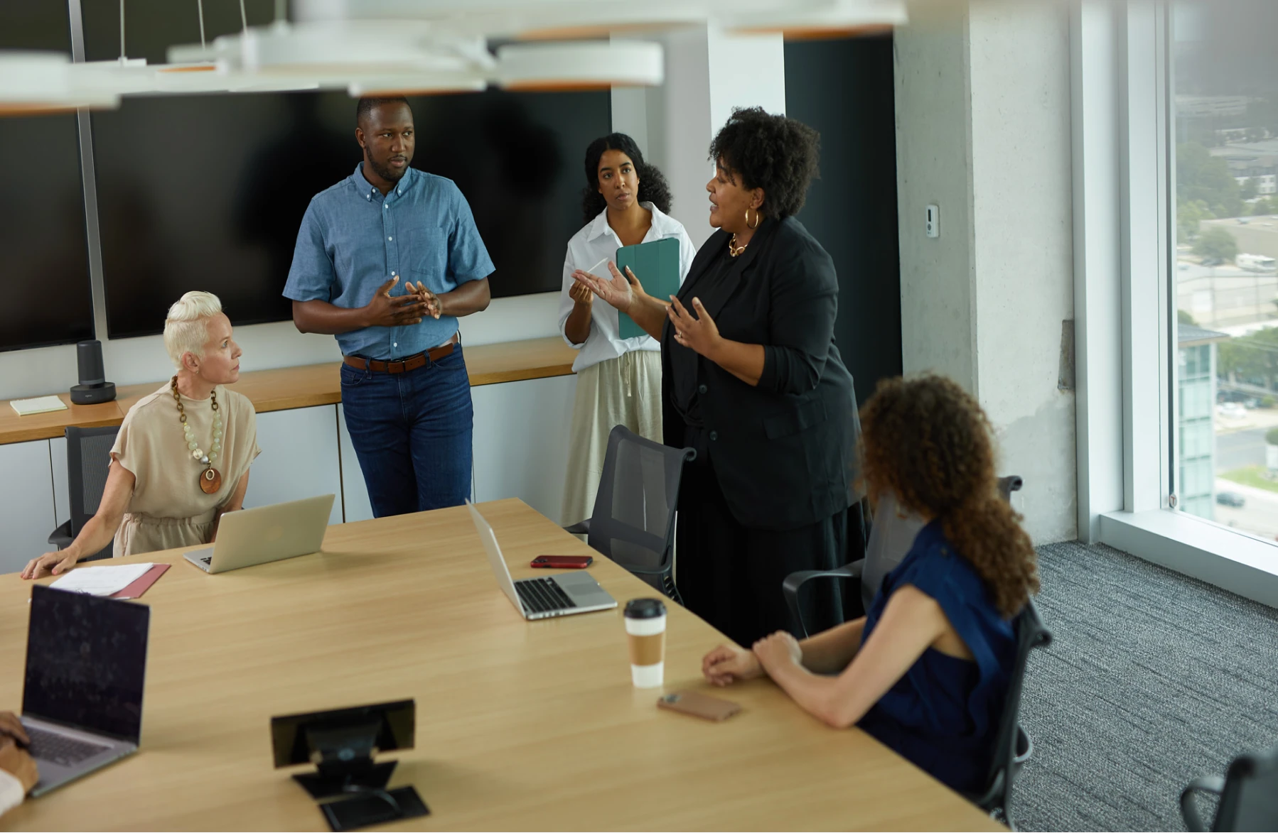 a diverse group of coworkers meeting in an office and discussing the benefits of the Employer Branding Hub