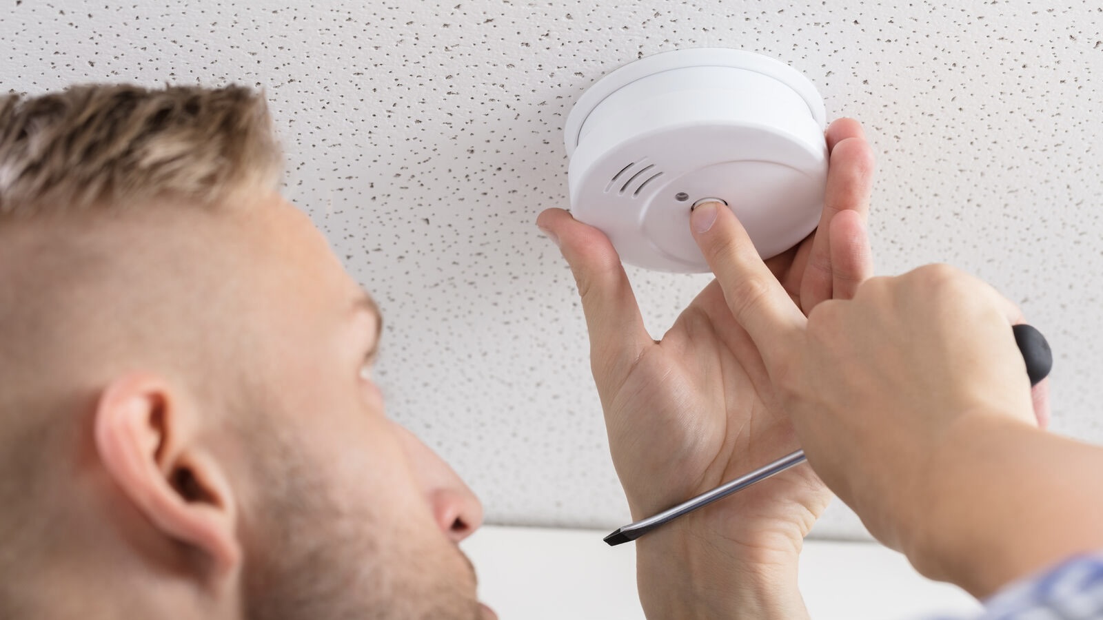 A man testing his CO detector