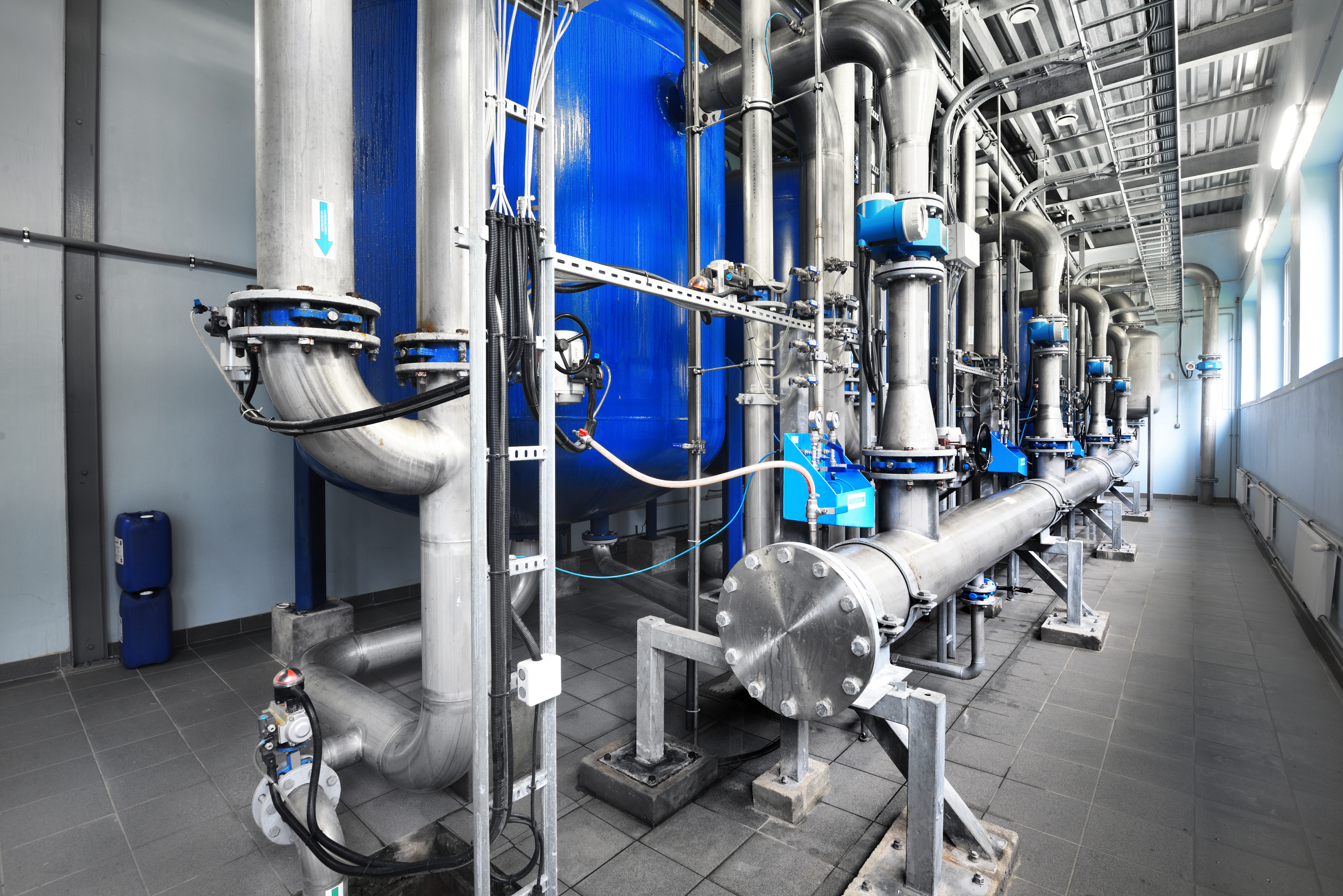 large-industrial-water-treatment-boiler-room-steel-metal-pipes-pumps-valves.jpg