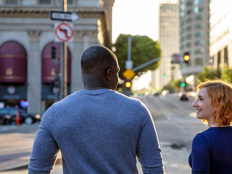Friends walking on the street and talking in English