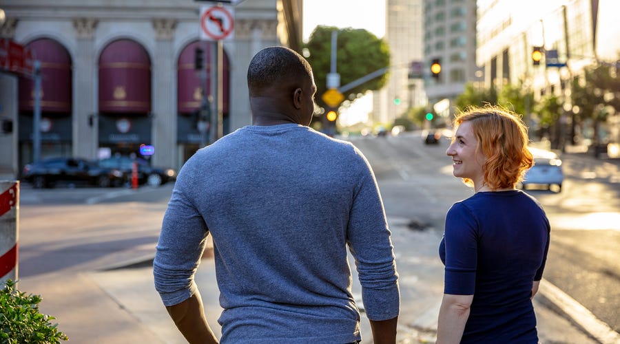 Friends walking on the street and talking in English