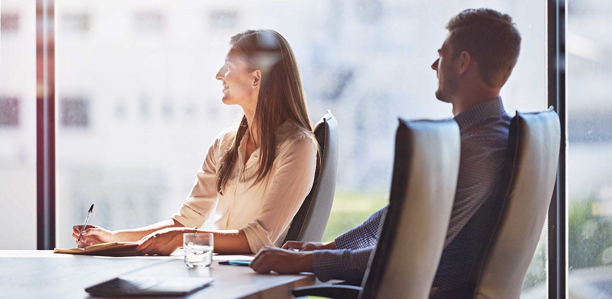 Legal team during a meeting sitting around a desk and talking to each other