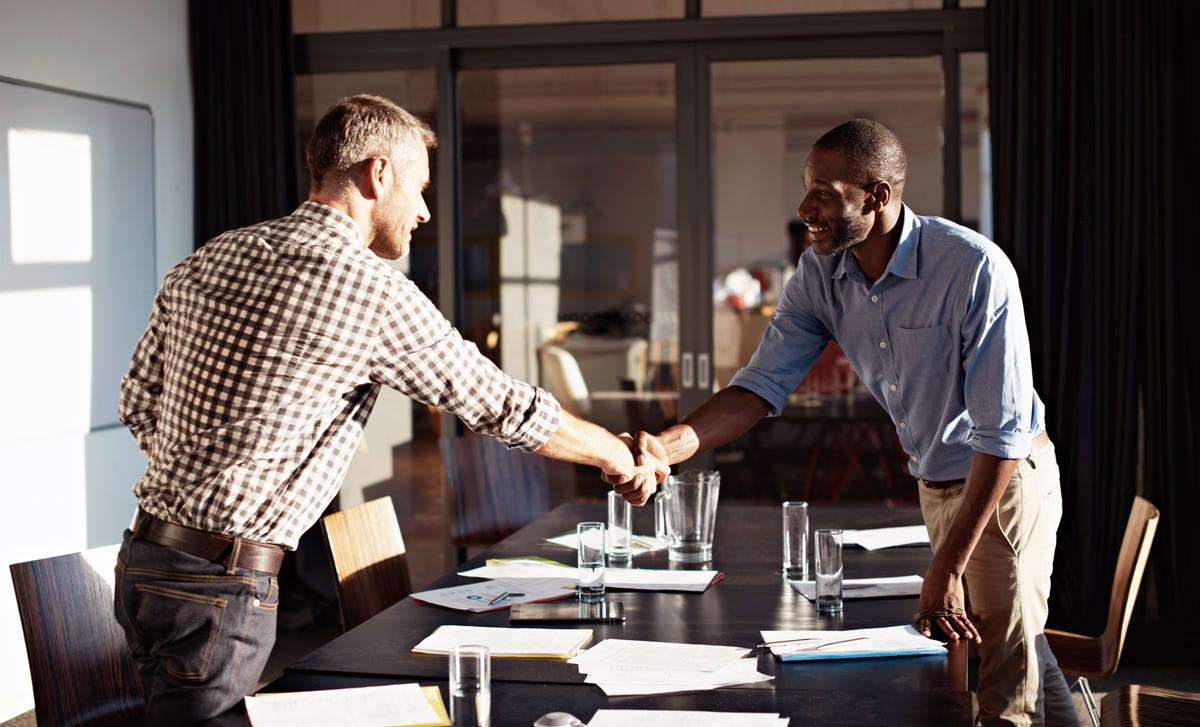 Two men shaking hands before a job interview at Berlitz