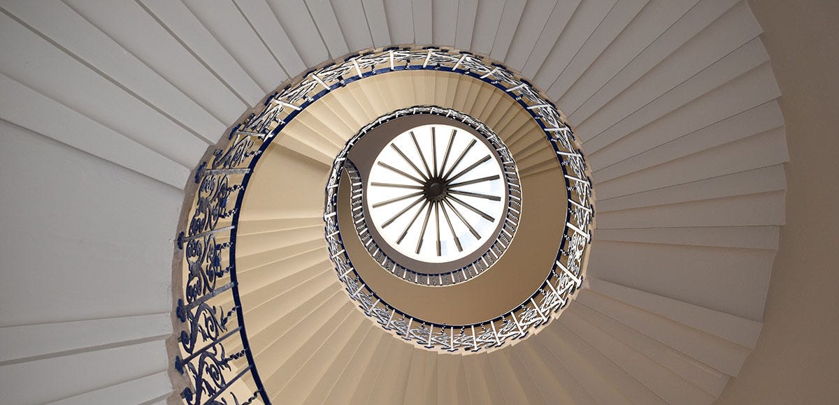 A white spiral staircase inside a building