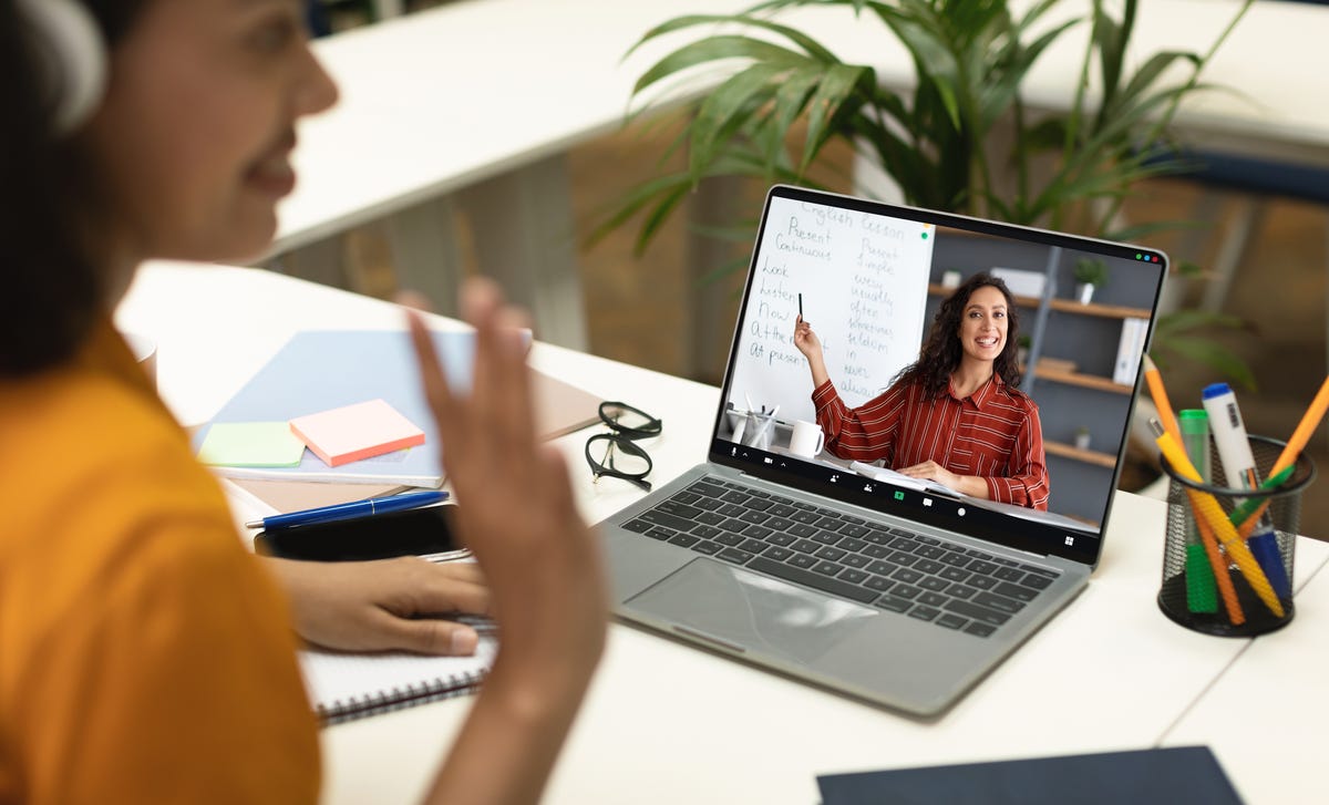 Nouveau formateur montrant des mots à son élève dans la langue cible sur l'écran de l'ordinateur pendant l'un de ses cours de langue privés en ligne.