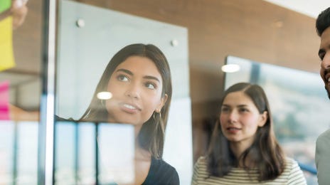 Students and instructor looking at sticky notes together during a CLOE preparation course with Berlitz France