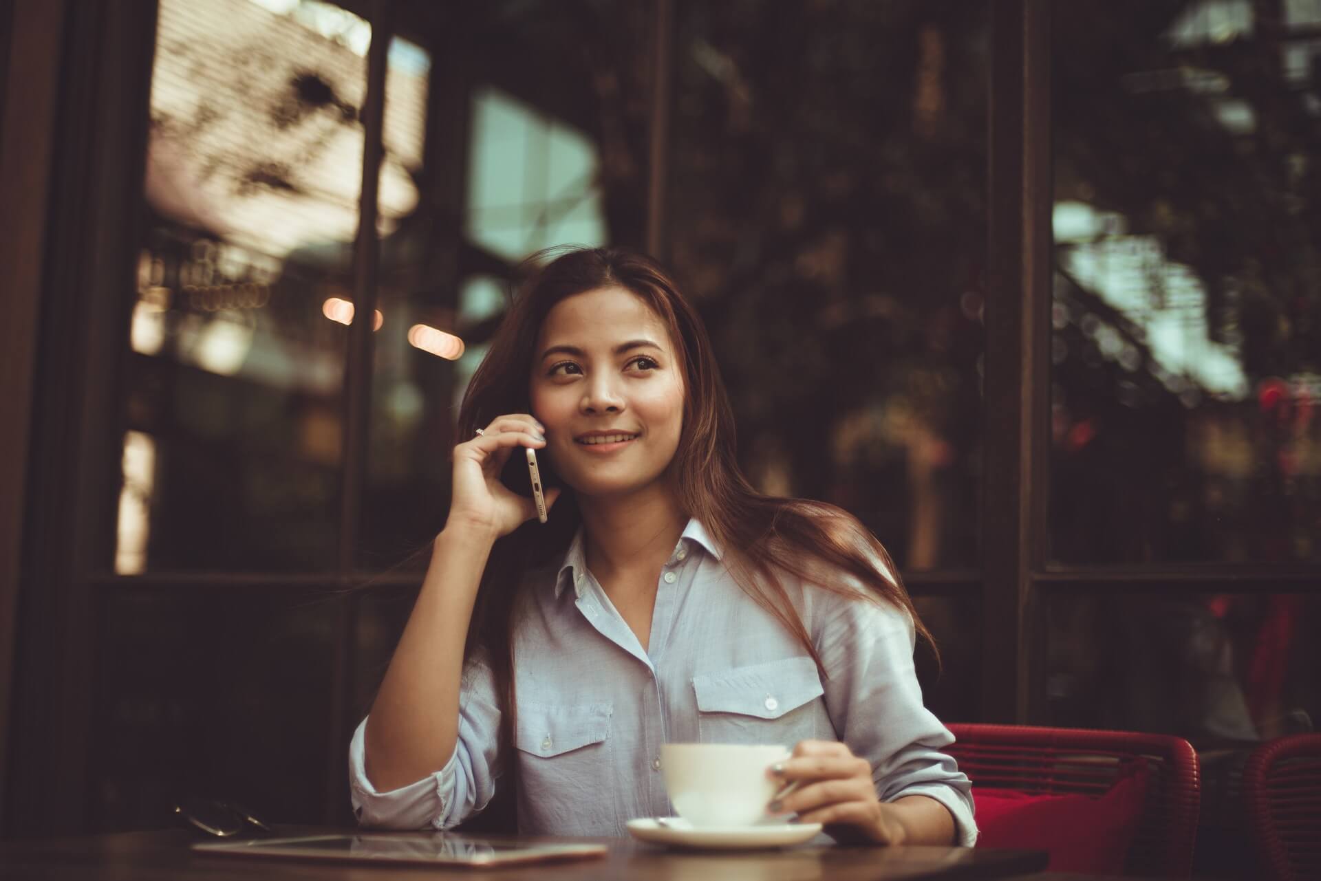 Woman on her phone greeting a friend