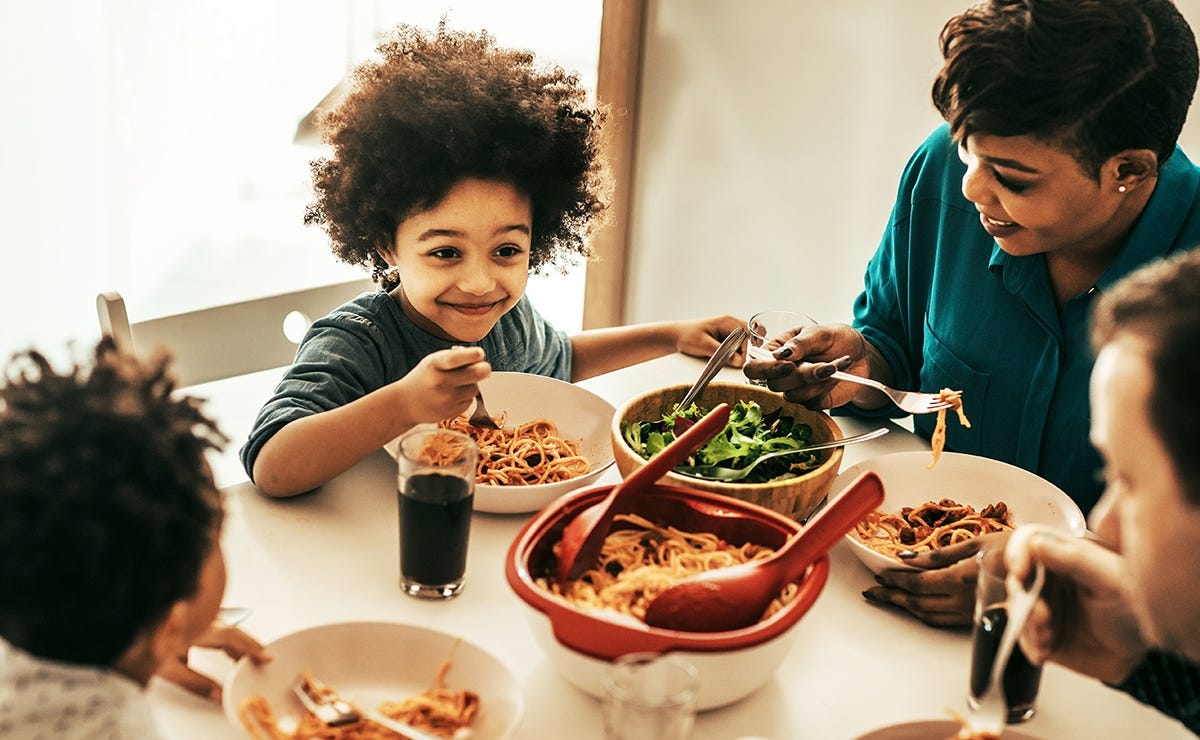 Small child saying thank you during dinner with the family