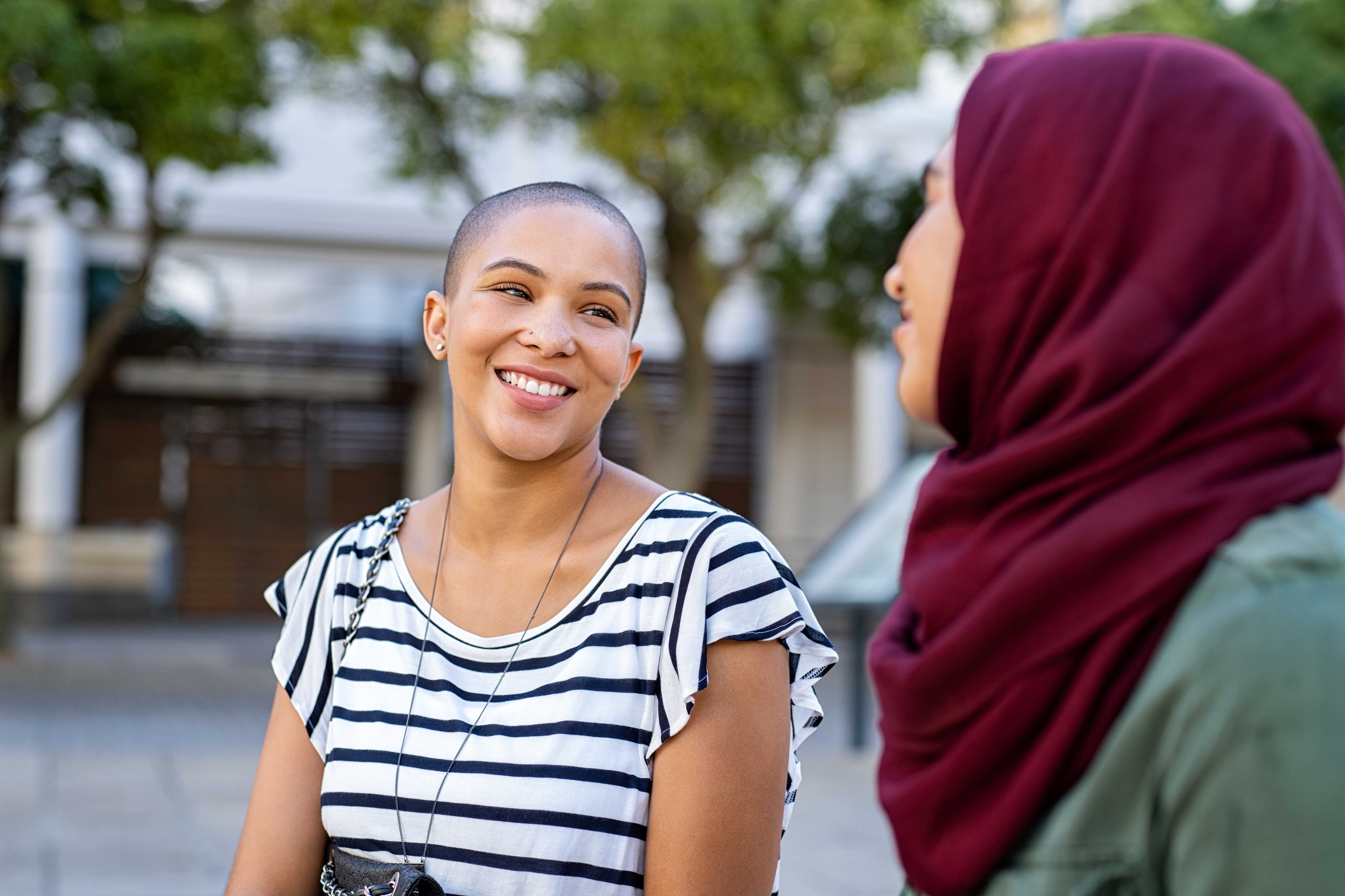 Native-fluent instructor talking to her student and teaching her a foreign language