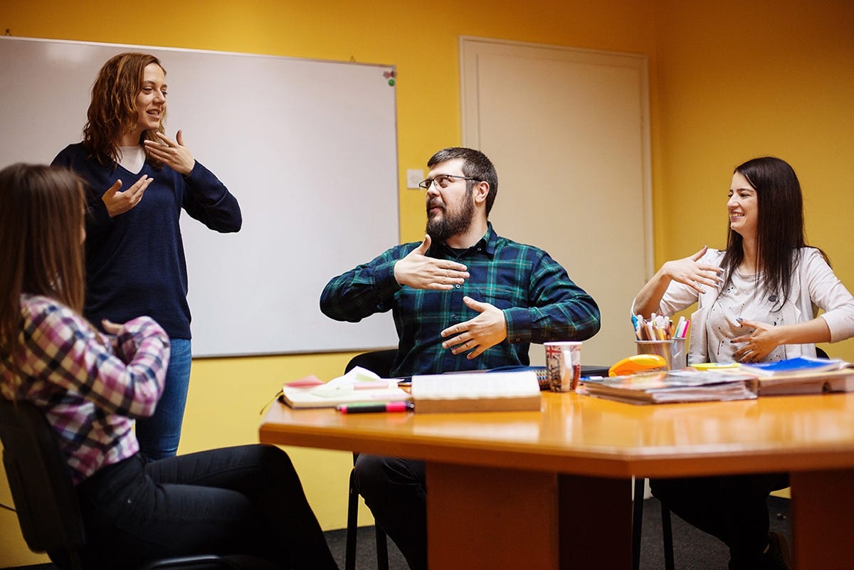 A group os students talking to their instructor about the months in English 