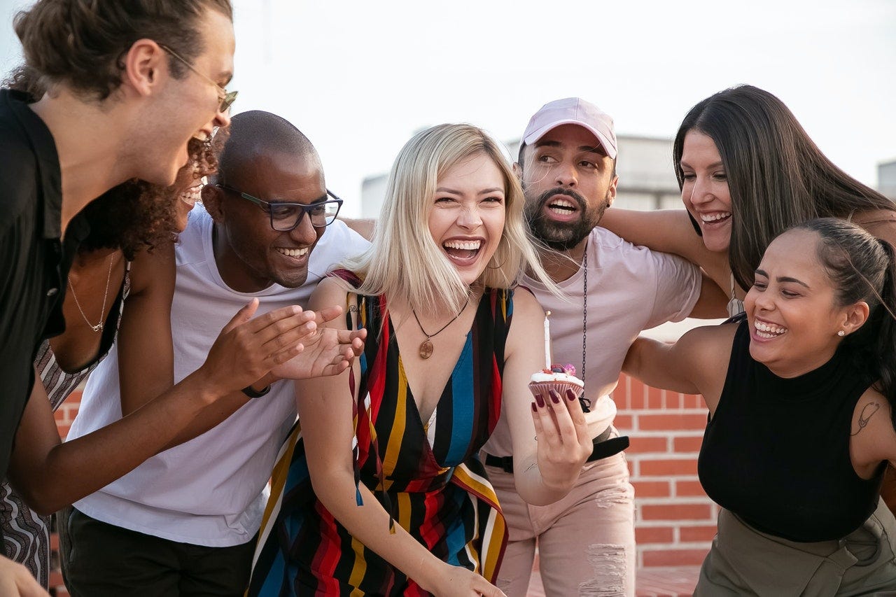 Group of friends celebrating a birthday during the weekend