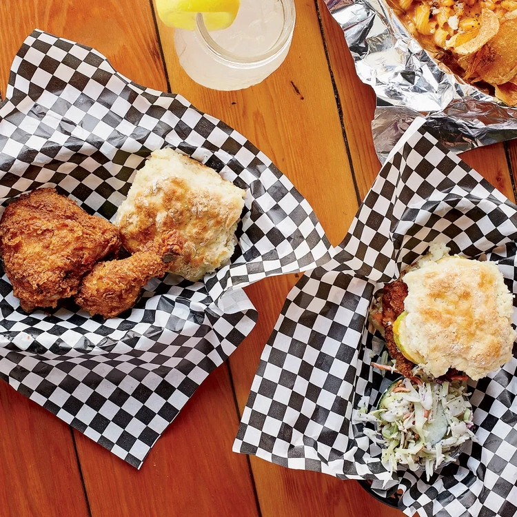 2 Pieces of Fried Chicken and a Biscuit in first basket. Chicken Biscuit with Cole slaw in the second basket.