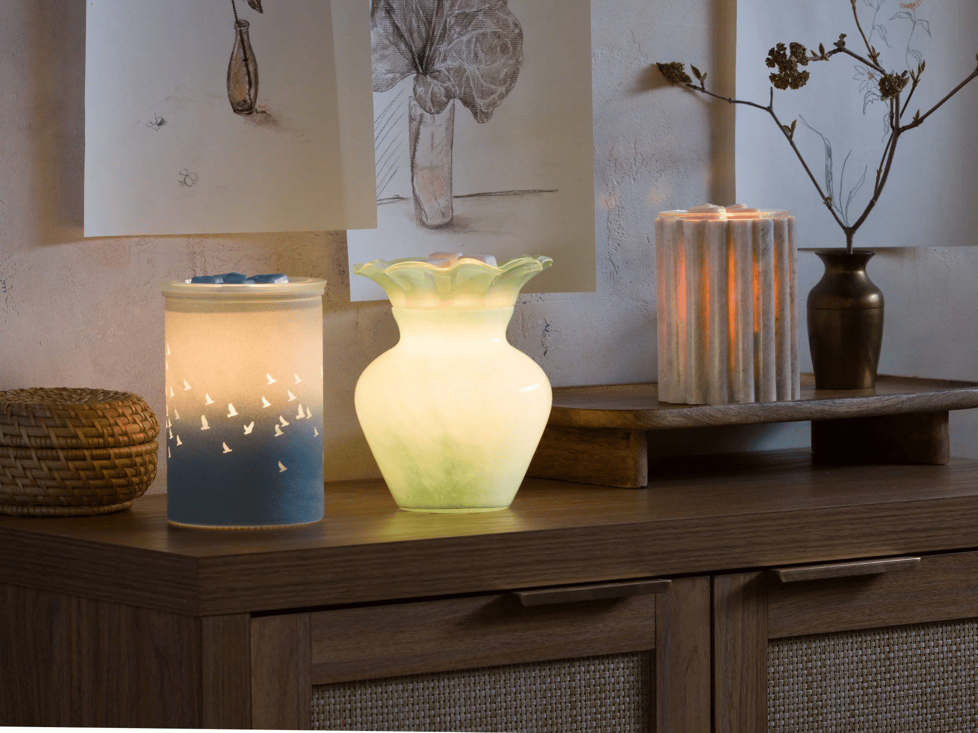 Warmers from the Warm decor line arranged in a cozy setting with soft lighting