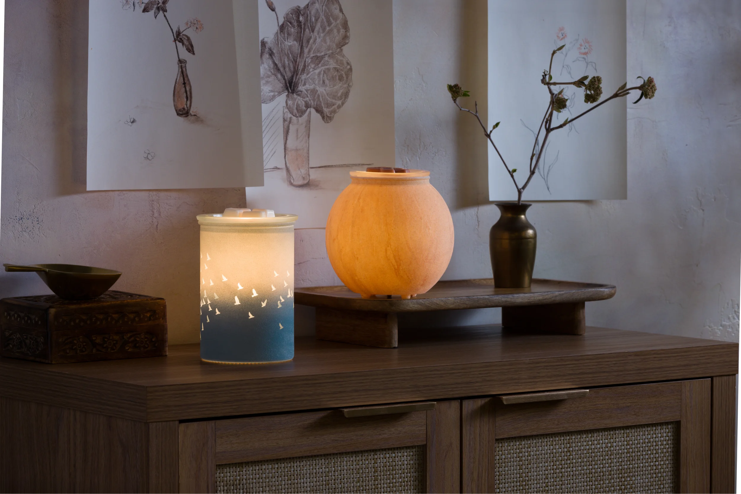 Warmers from the Warm decor line arranged in a cozy setting with soft lighting