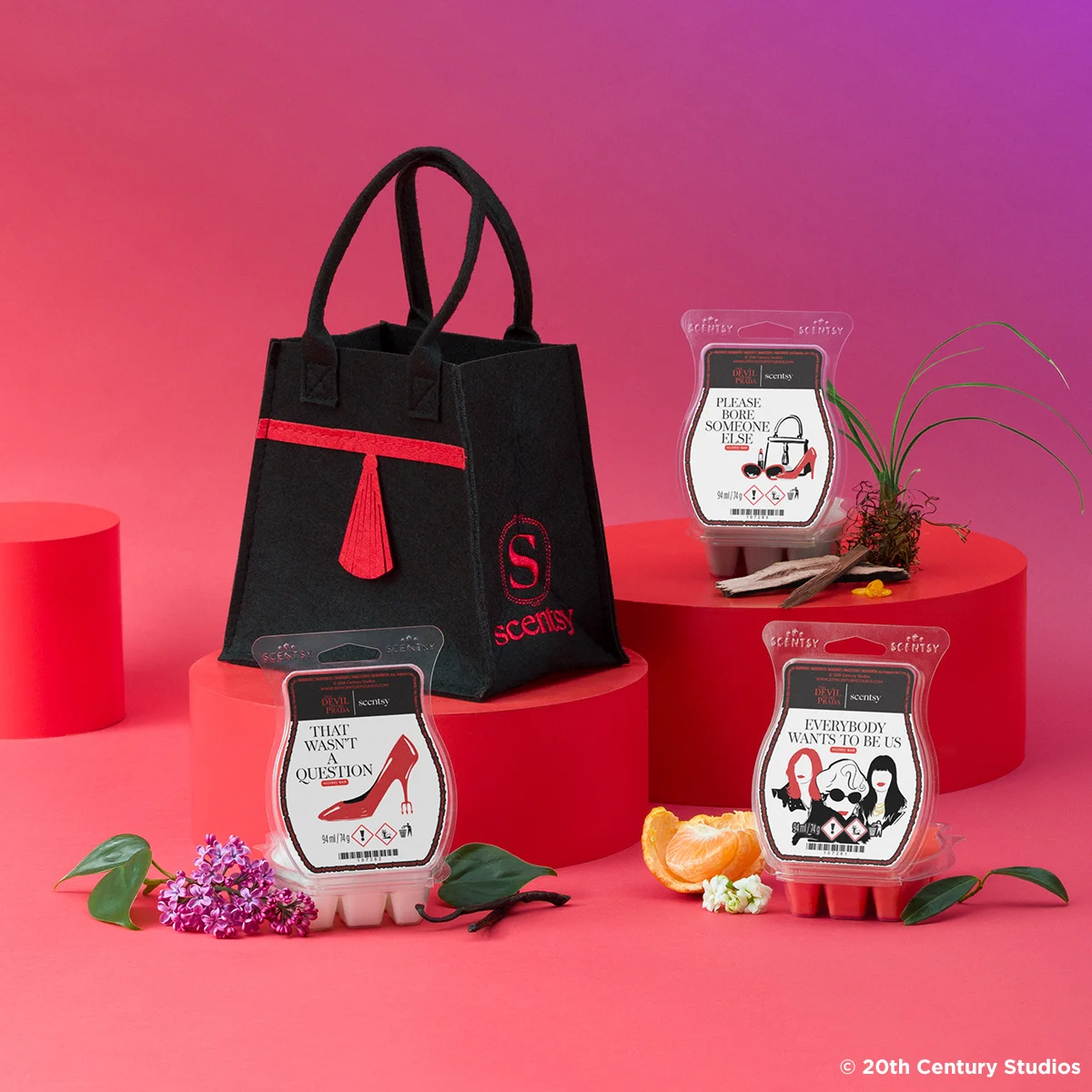 The Devil Wears Prada Collection is displayed on risers against a red and purple backdrop.