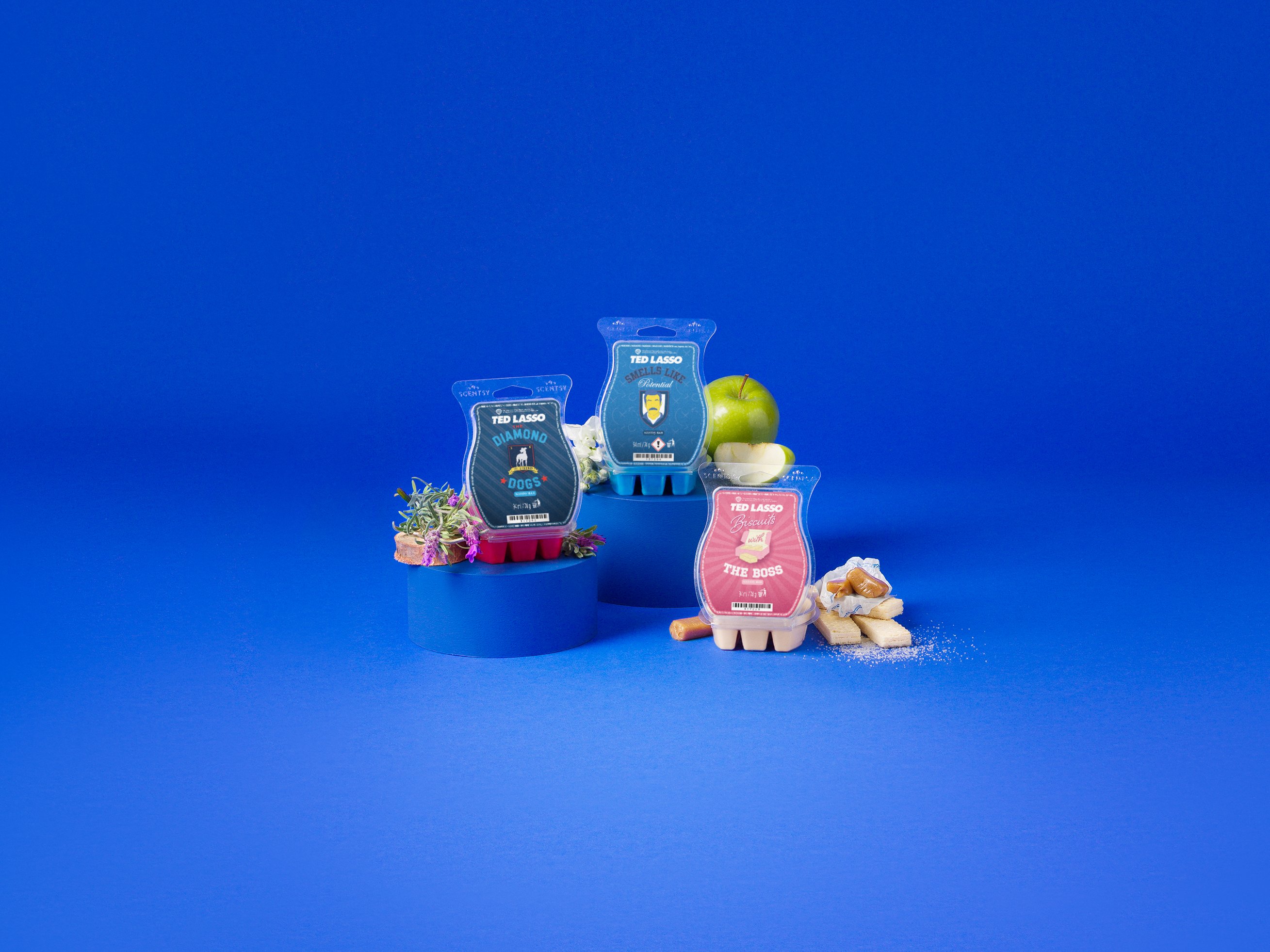 Ted Lasso Collection products are displayed with fragrance ingredients against a blue background.