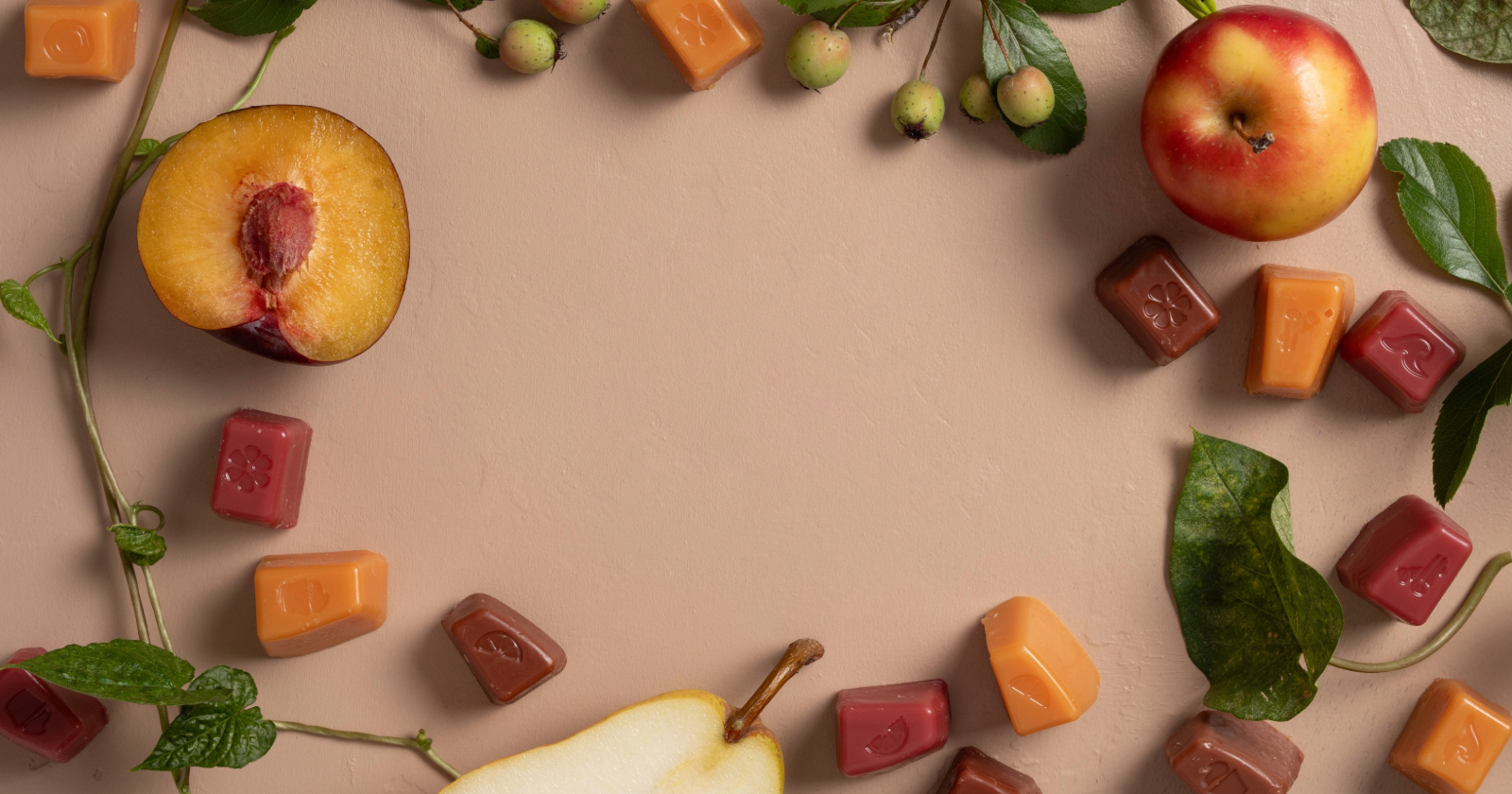 Scentsy wax cubes in a vibrant peach and pear scent, surrounded by fresh peach and pear halves with lush greenery.