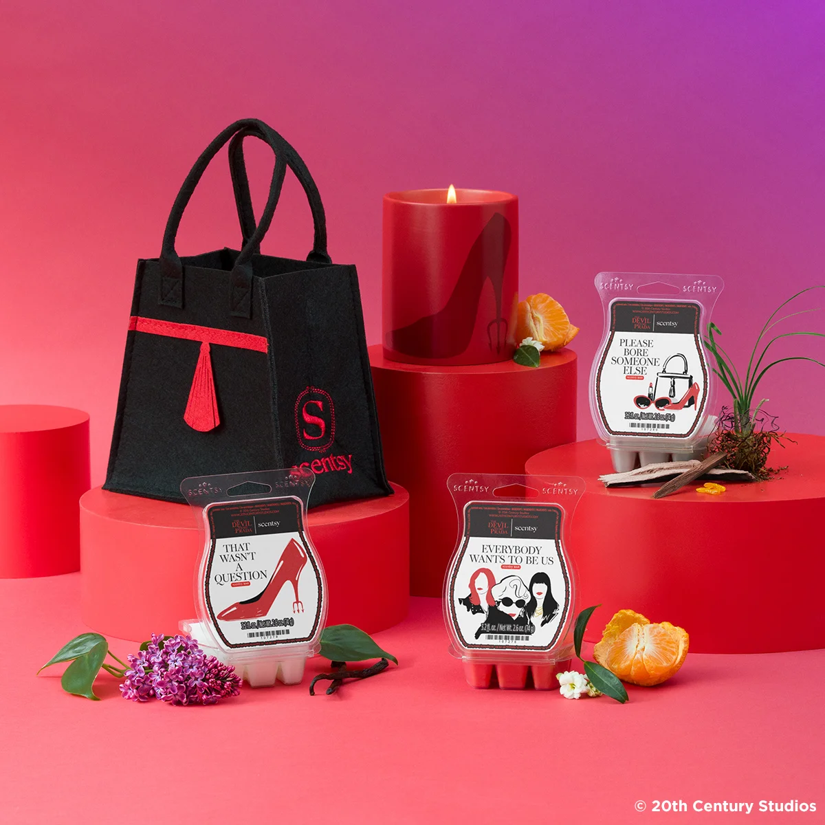 The Devil Wears Prada Collection is displayed on risers against a red and purple backdrop.