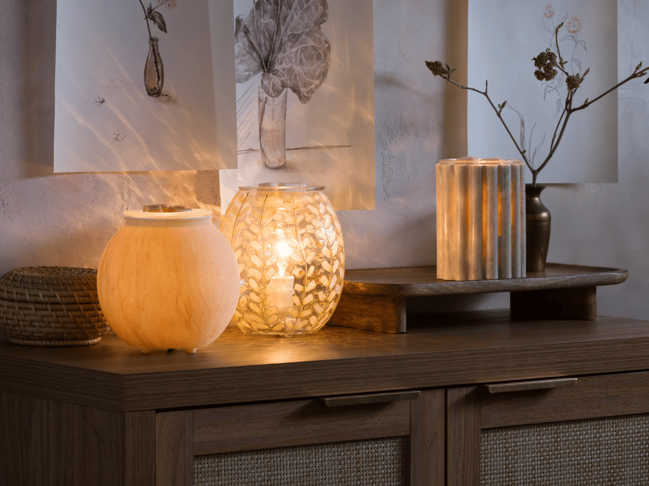 Warmers from the Warm decor line arranged in a cozy setting with soft lighting