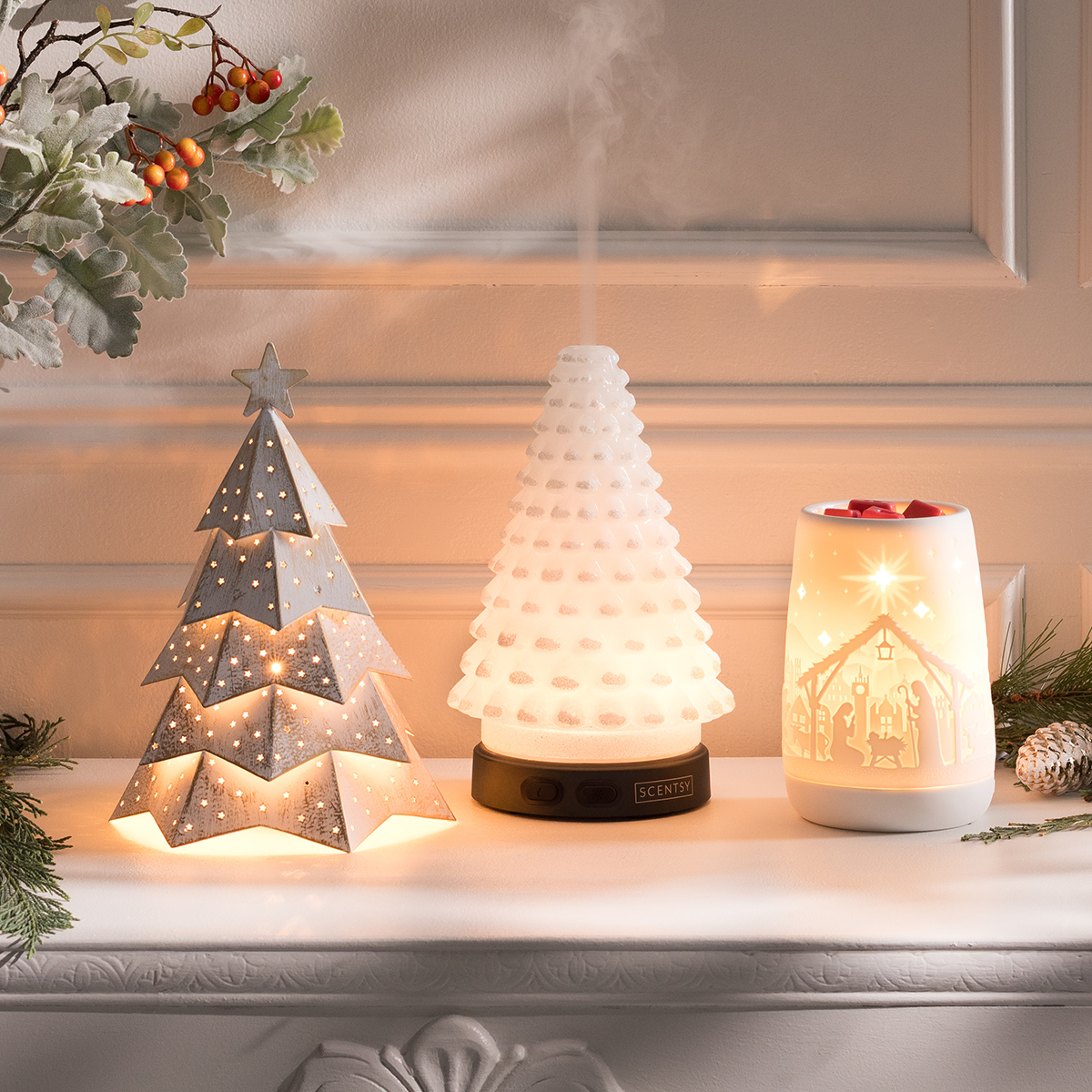 Festive holiday display featuring two Scentsy Warmers and the Aurora Frost Premium Diffuser from the Holiday Collection, softly glowing and releasing mist to create a warm and inviting seasonal ambiance.
