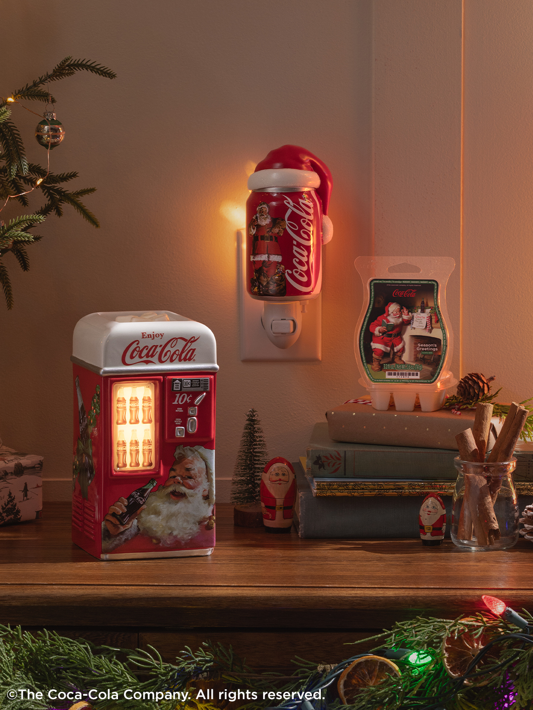 Products from the Coca-Cola Holiday Collection are displayed among festive decorations.