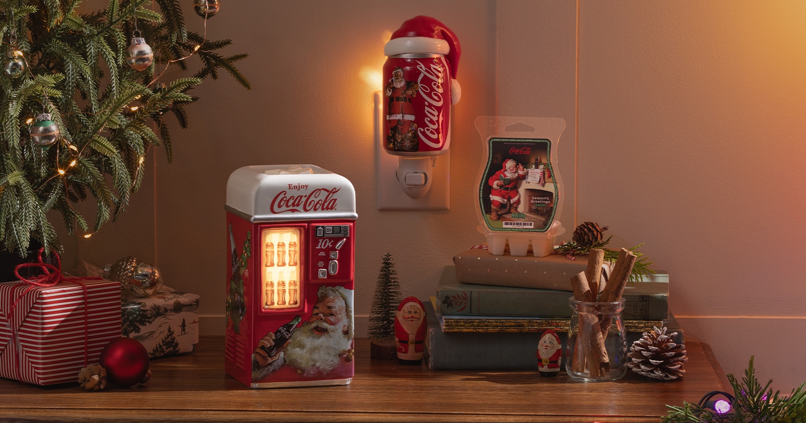 Products from the Coca-Cola Holiday Collection are displayed among festive decorations.