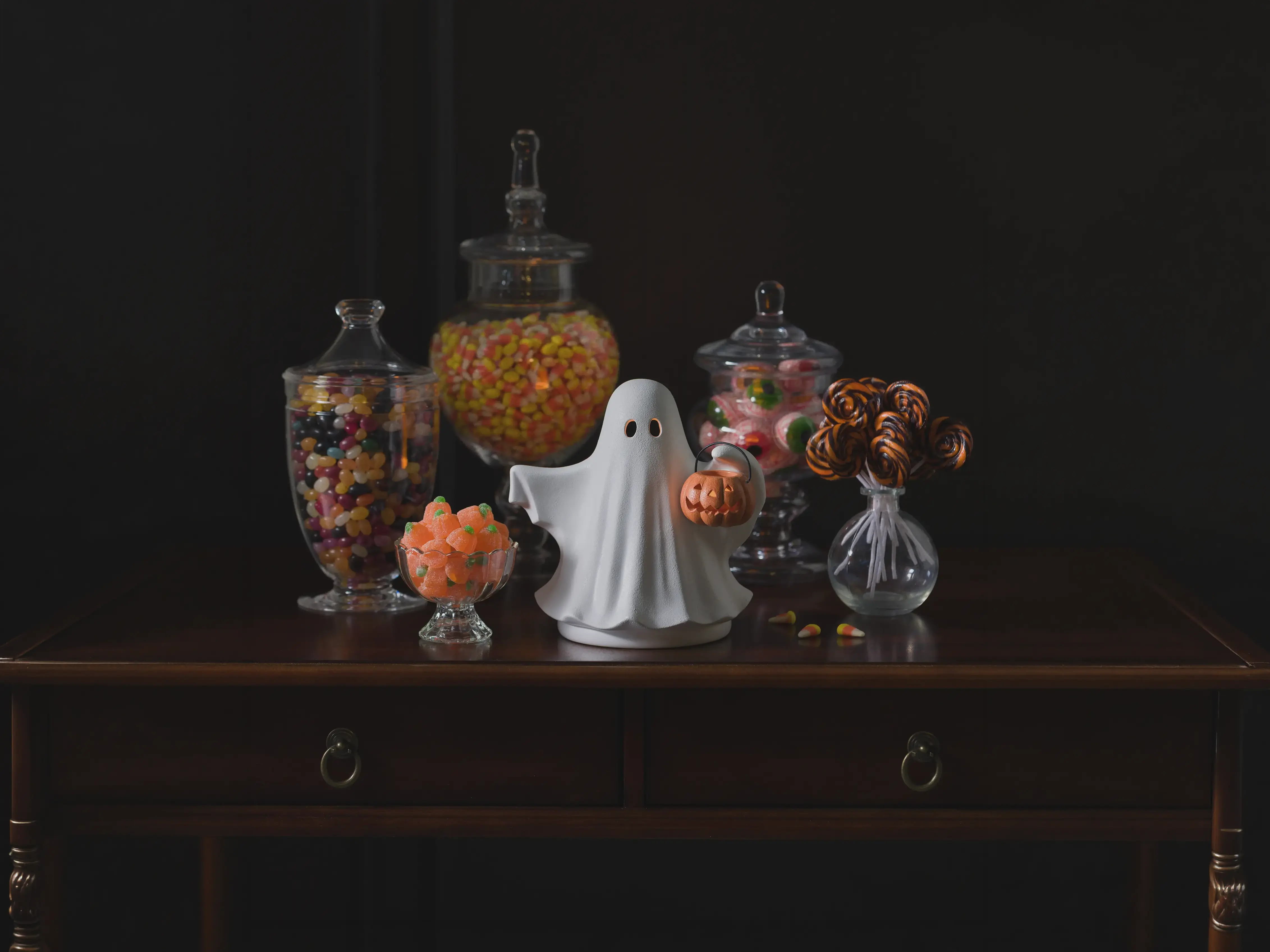 Halloween Edit Warmers on display in a dark, haunting setting with black and red accents, antique books and dried fruit.