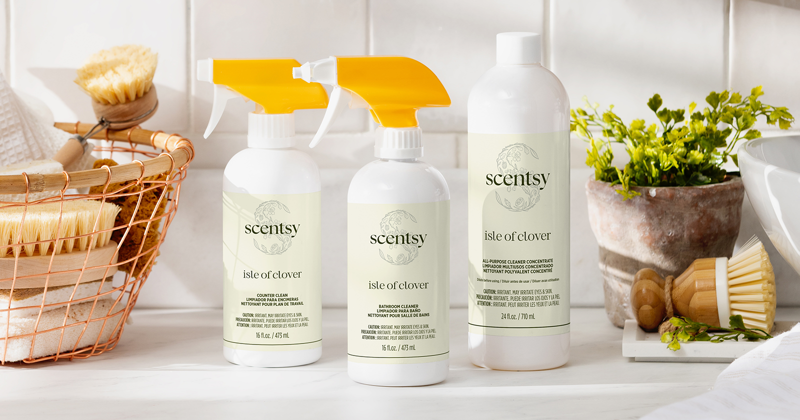 Scentsy cleaning products displayed on a countertop with natural décor in a bright, fresh home setting.