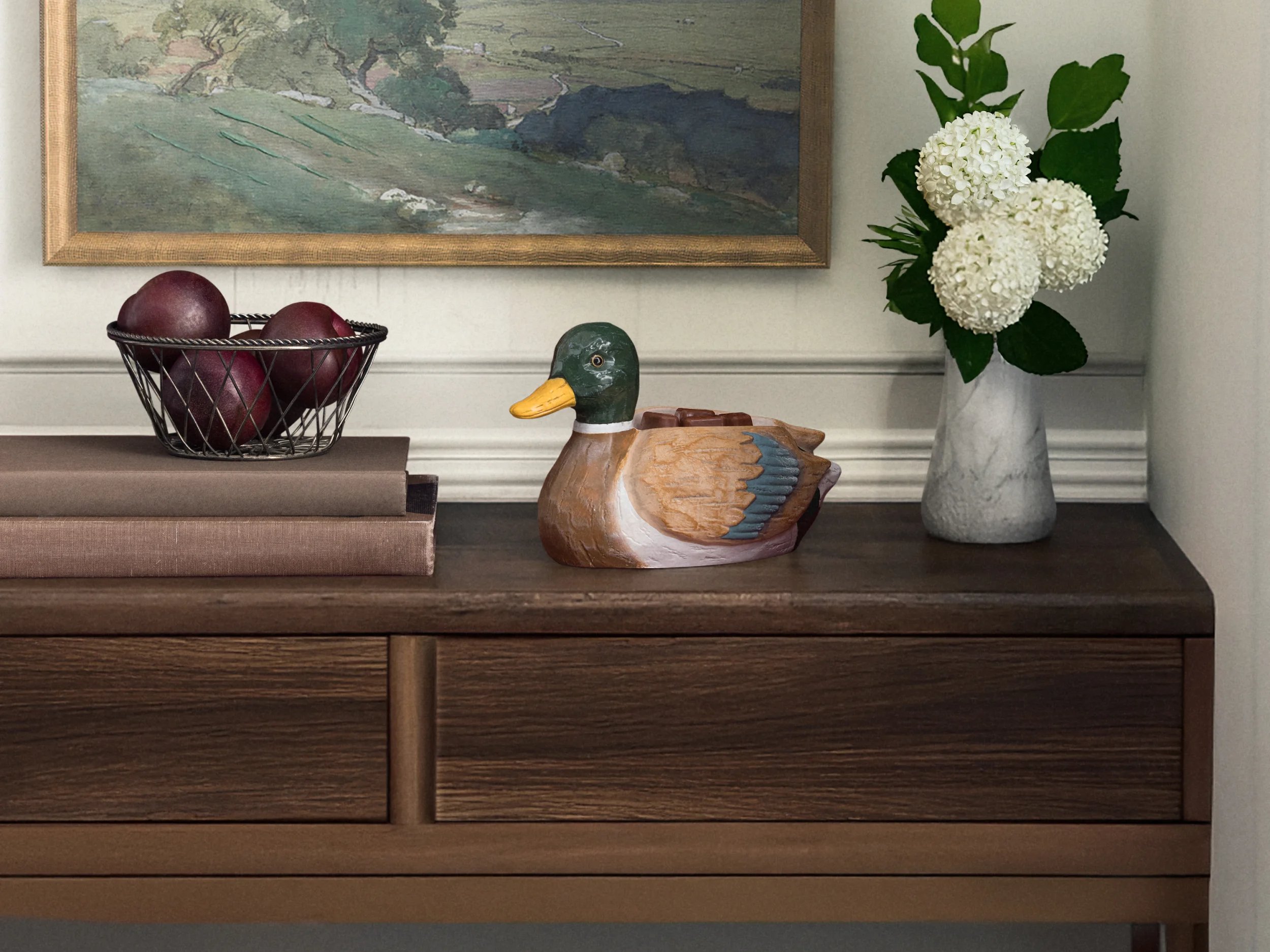 A Scentsy fragrance oil bottle is showcased with flowers against a dreamy green backdrop.