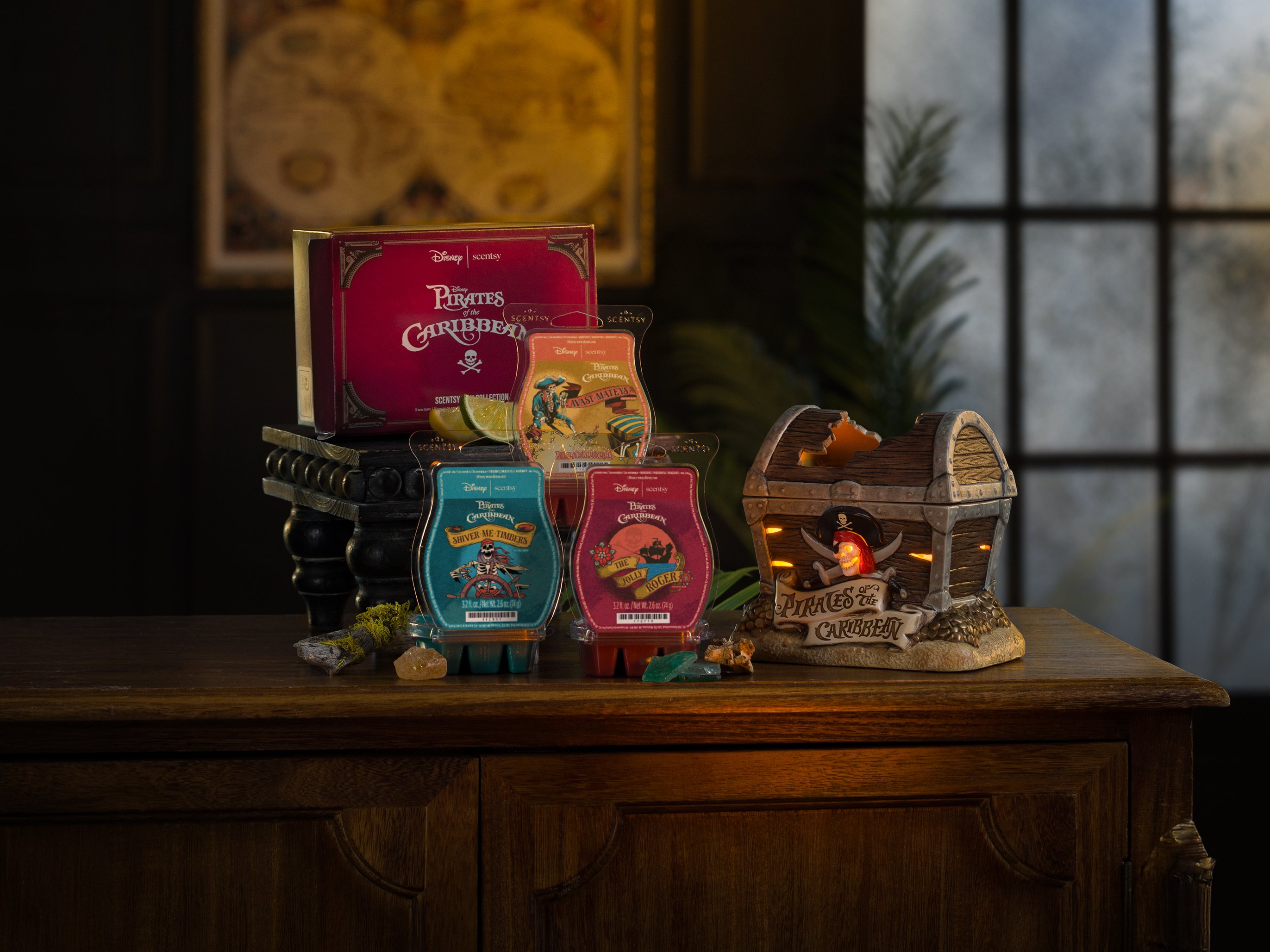 Disney Pirates of the Caribbean products are arranged on a table in a low-light environment. 