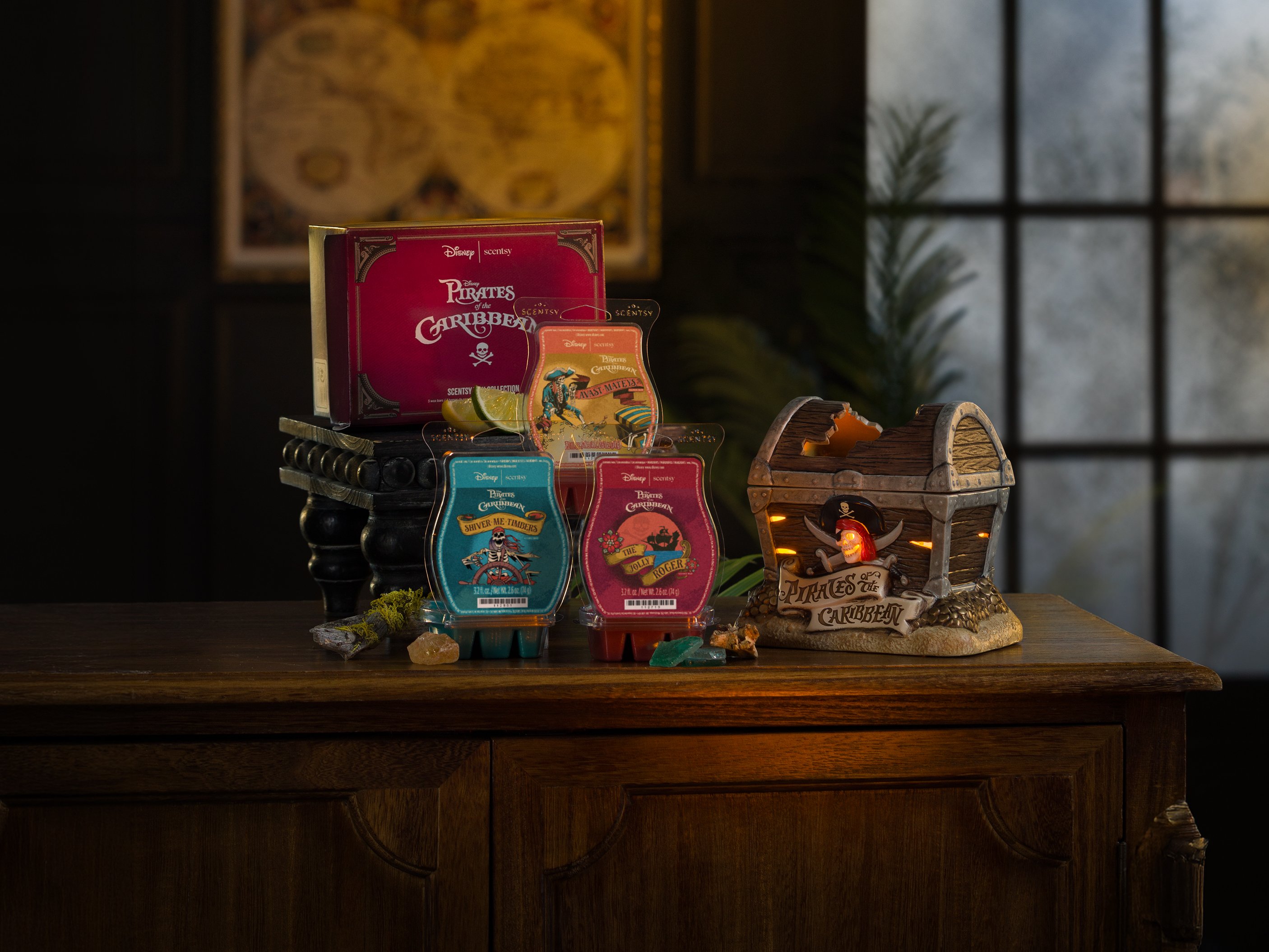 Disney Pirates of the Caribbean products are arranged on a table in a low-light environment. 