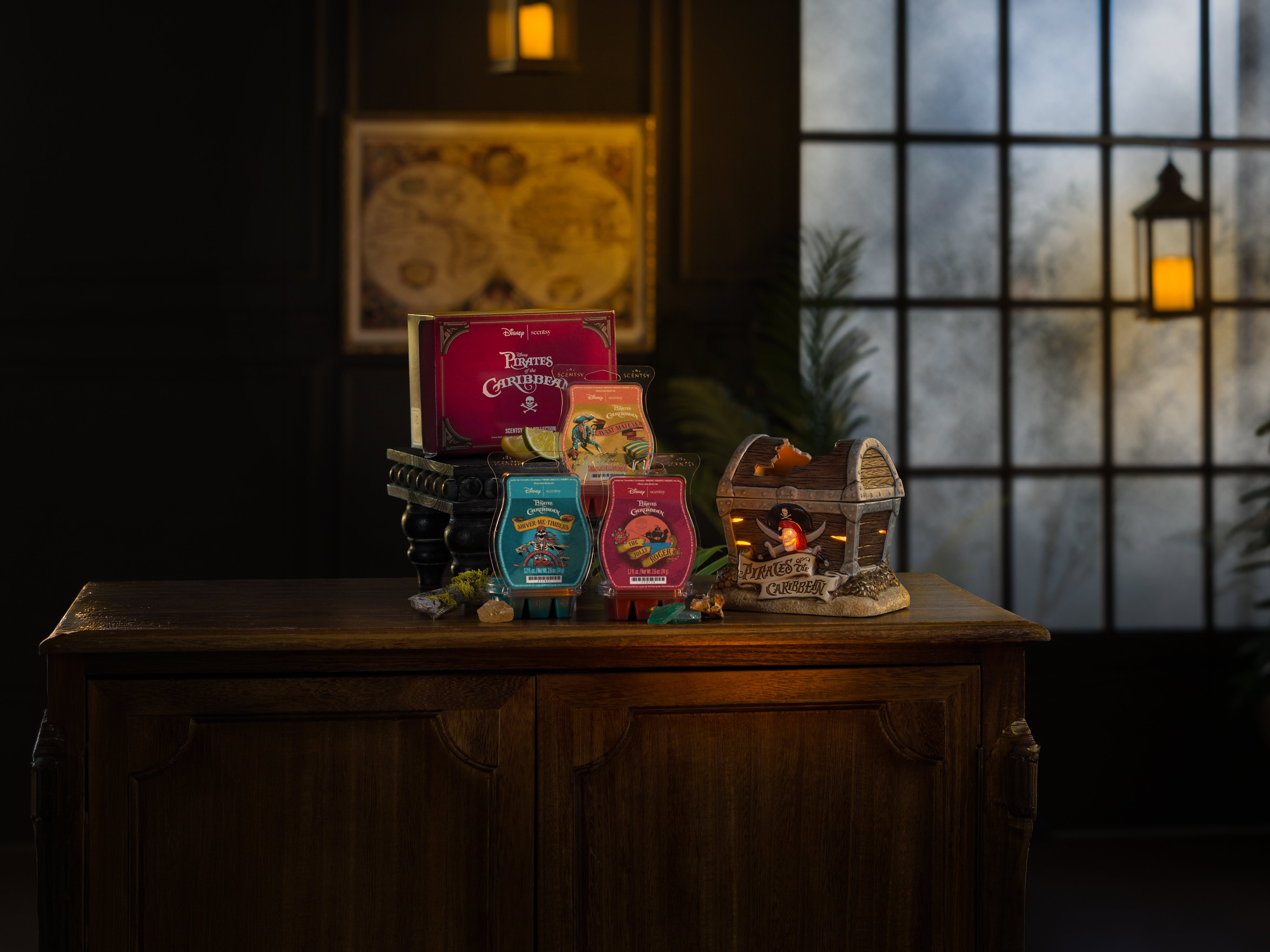 Disney Pirates of the Caribbean products are arranged on a table in a low-light environment. 