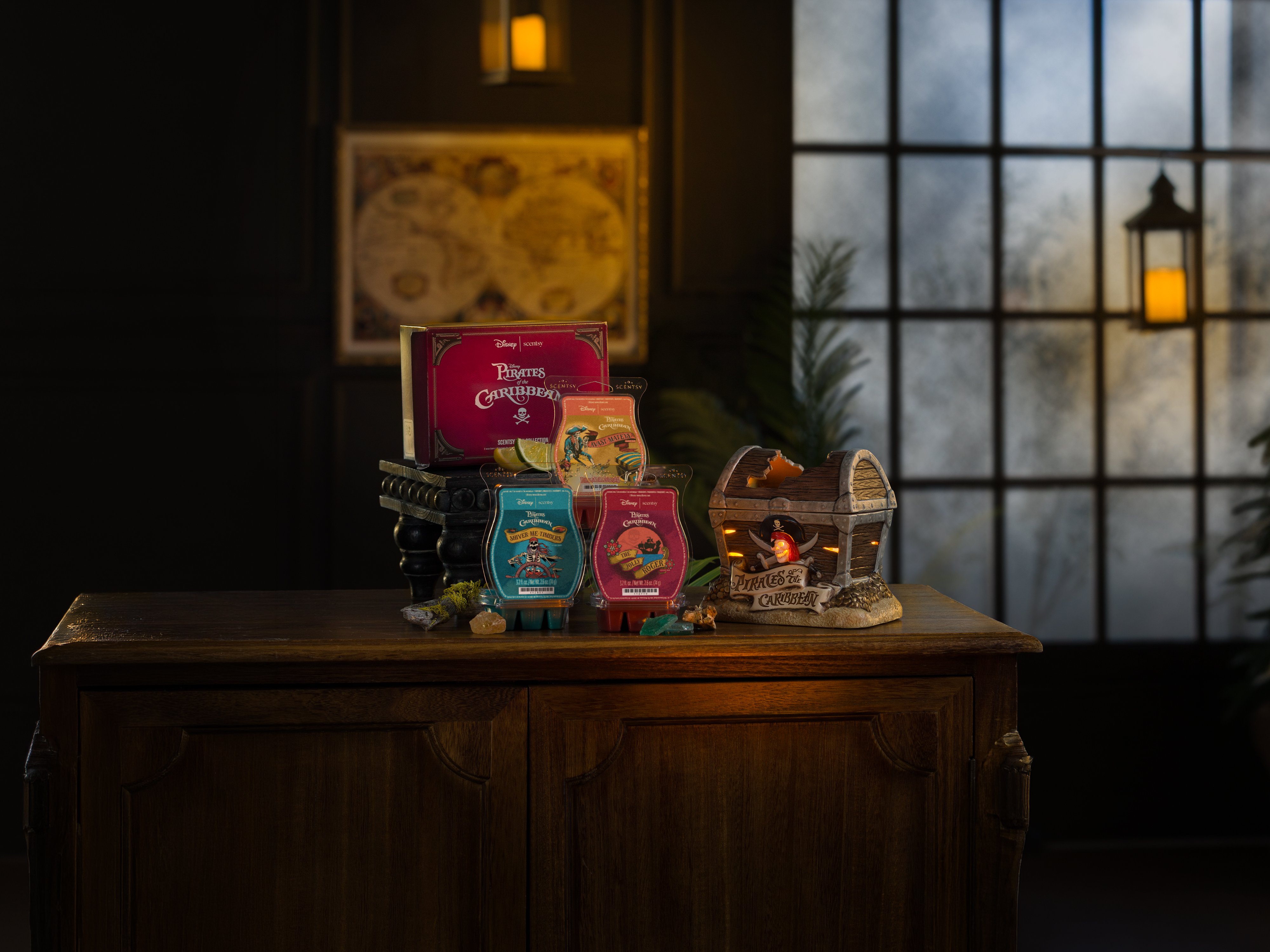 Disney Pirates of the Caribbean products are arranged on a table in a low-light environment. 