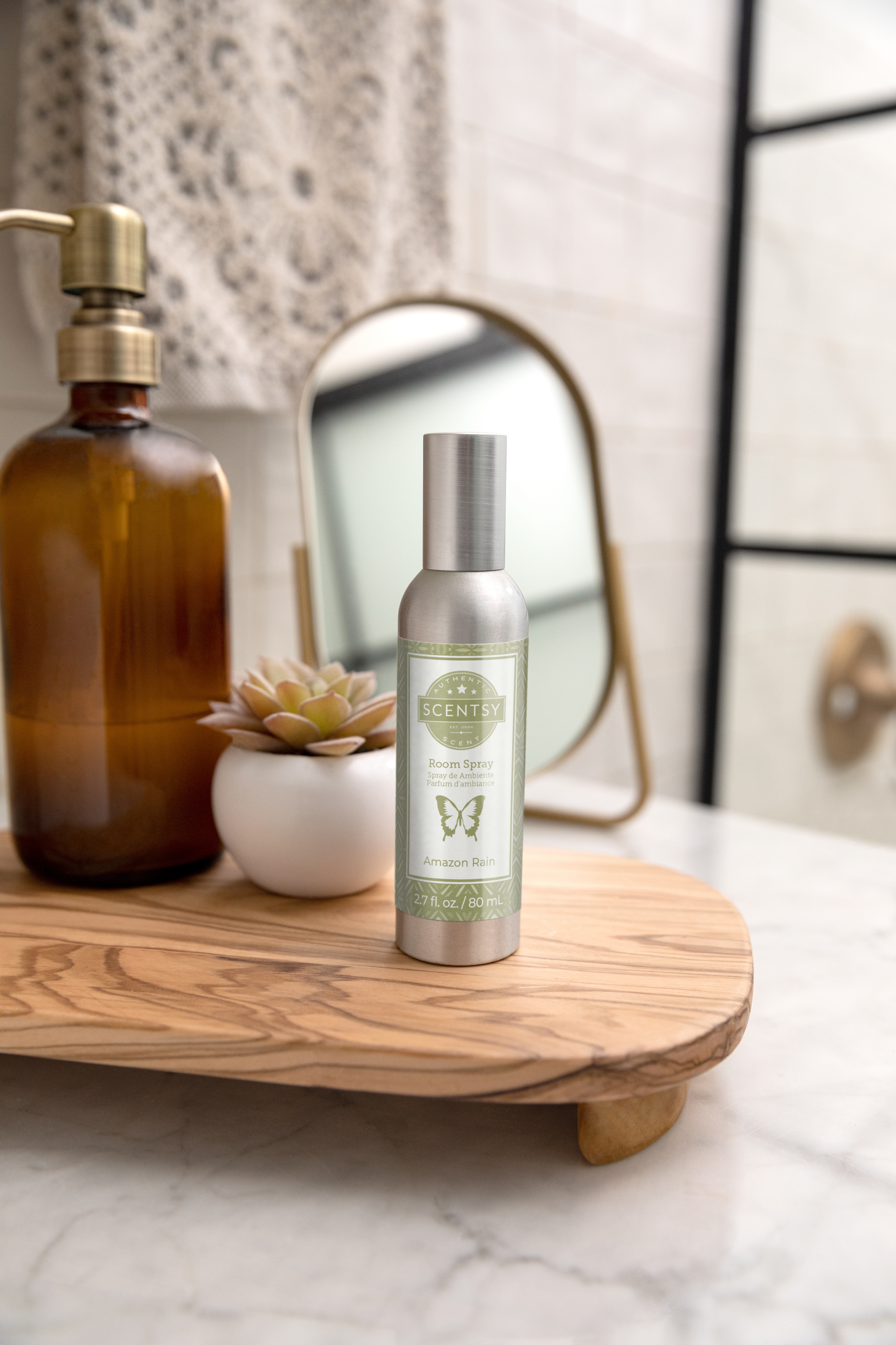 Scentsy Eucalyptus Wreath Candle in a glass jar, surrounded by lush green botanicals, set against a green background.