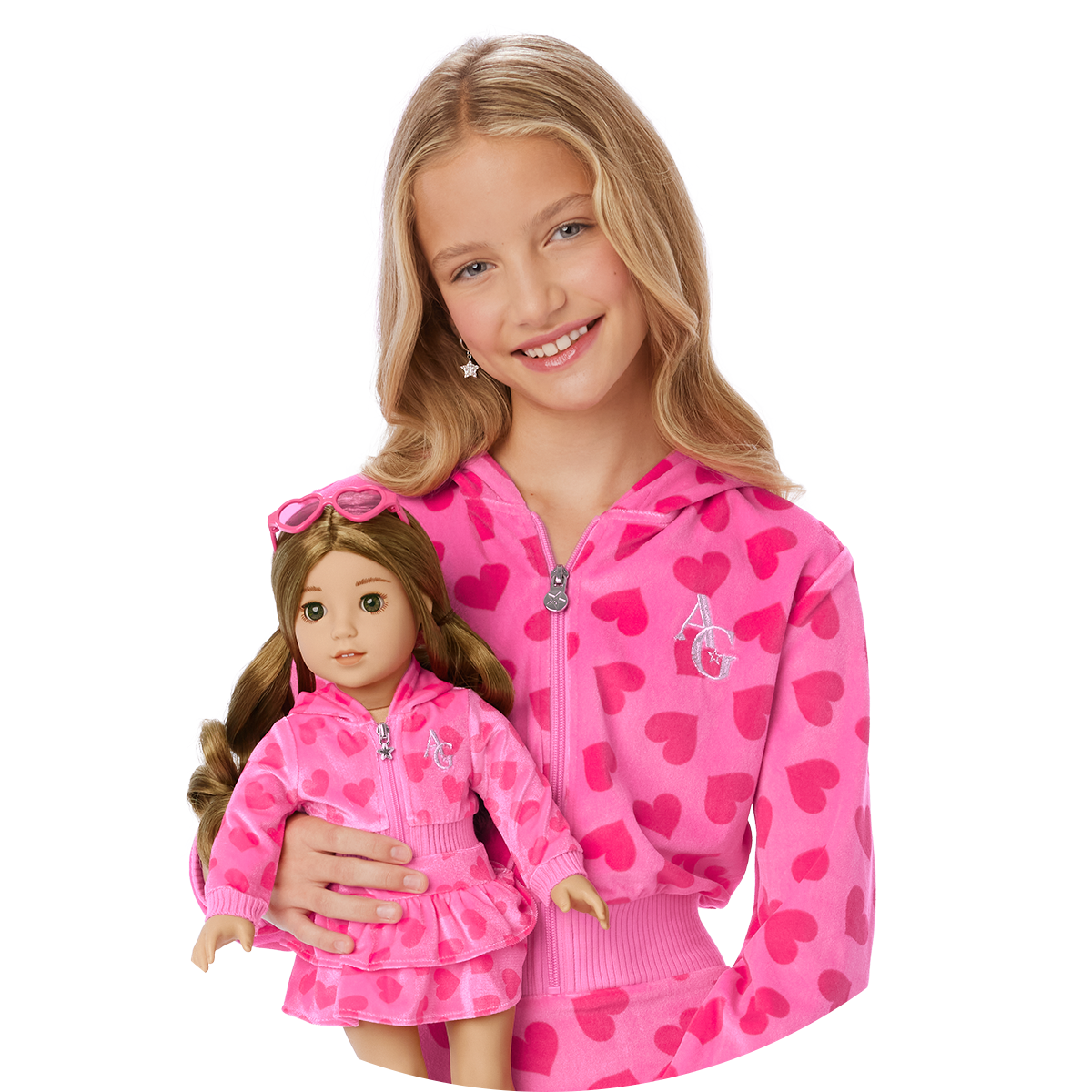 Girl in matching pink sweatsuit with doll