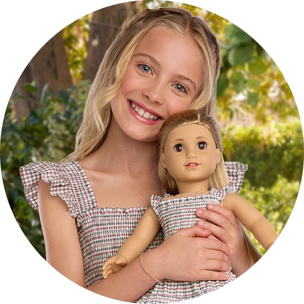 Young girl and doll in a matching dress set
