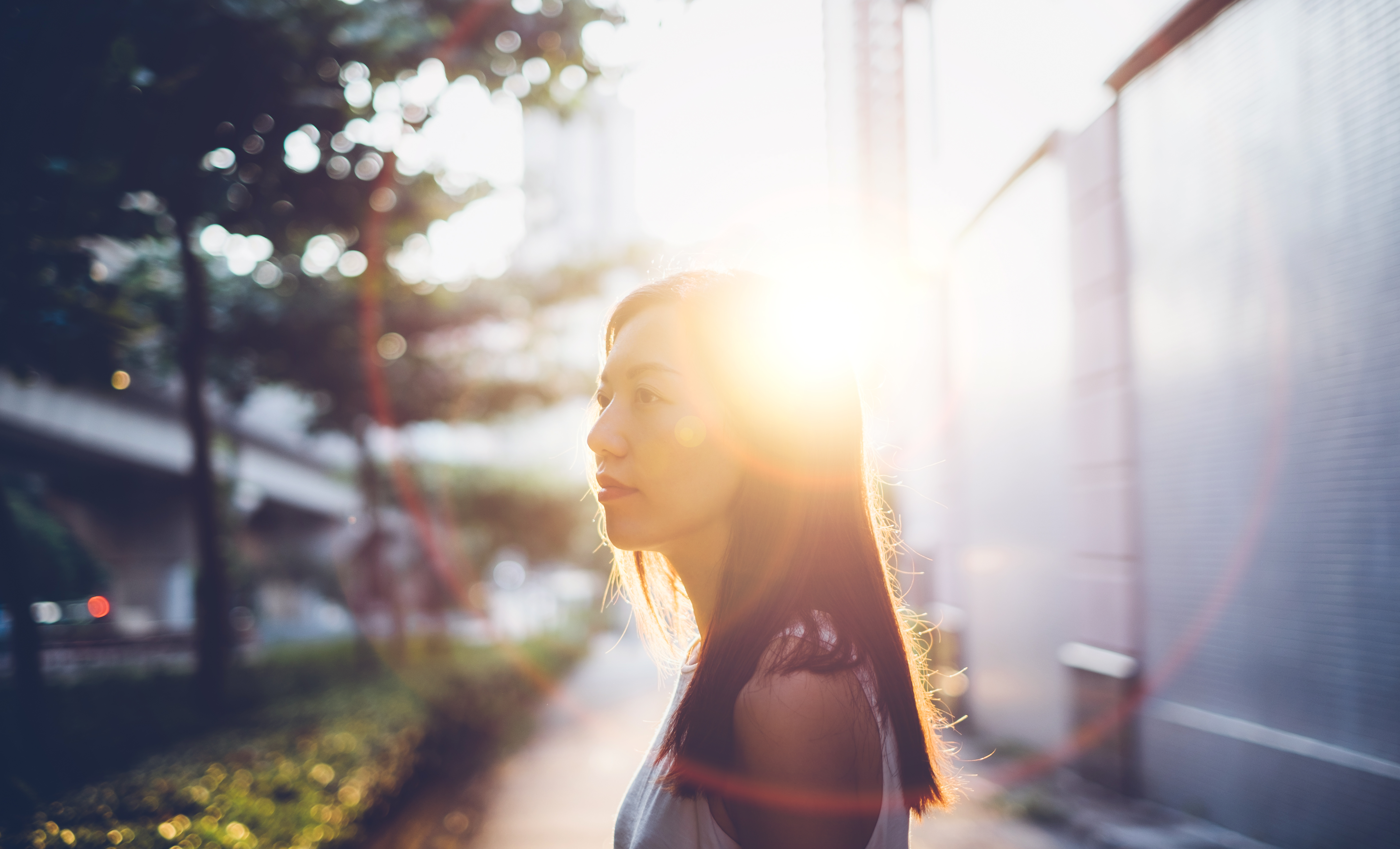 A blurred image of a girl with the sun in the background