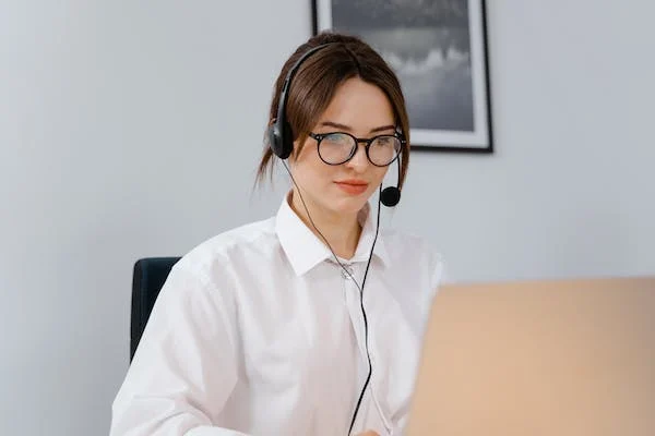 a female member of sales team wearing headphones