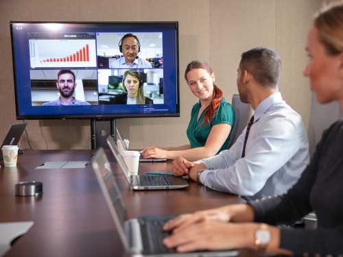 Employees using 8x8 HD video conferencing for real-time collaboration
